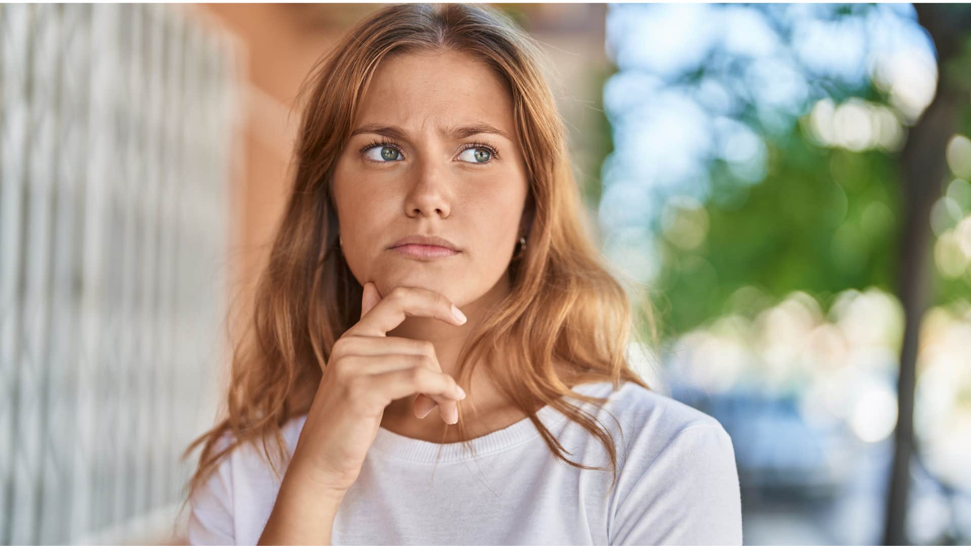 woman thinking of person she dislikes who reminds her of someone