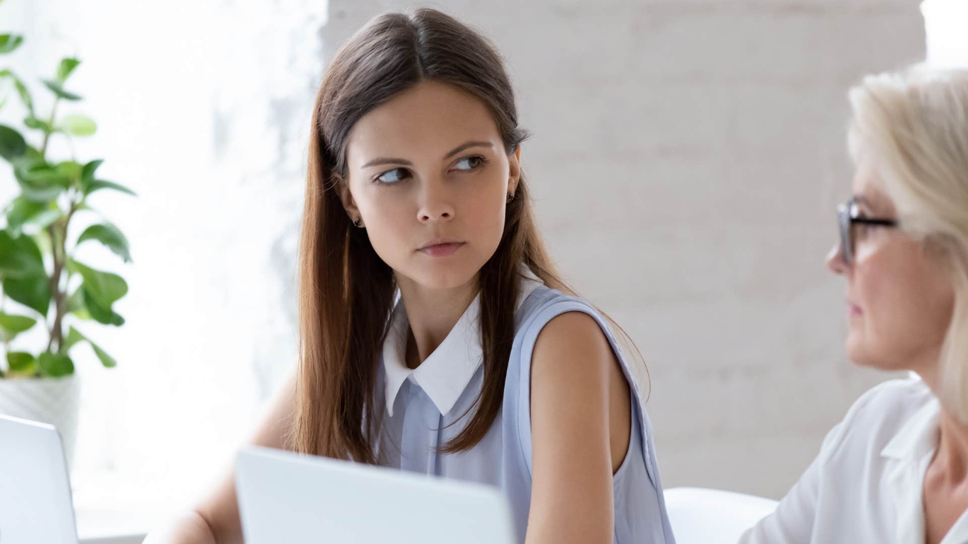 woman uncomfortable with successful co-worker
