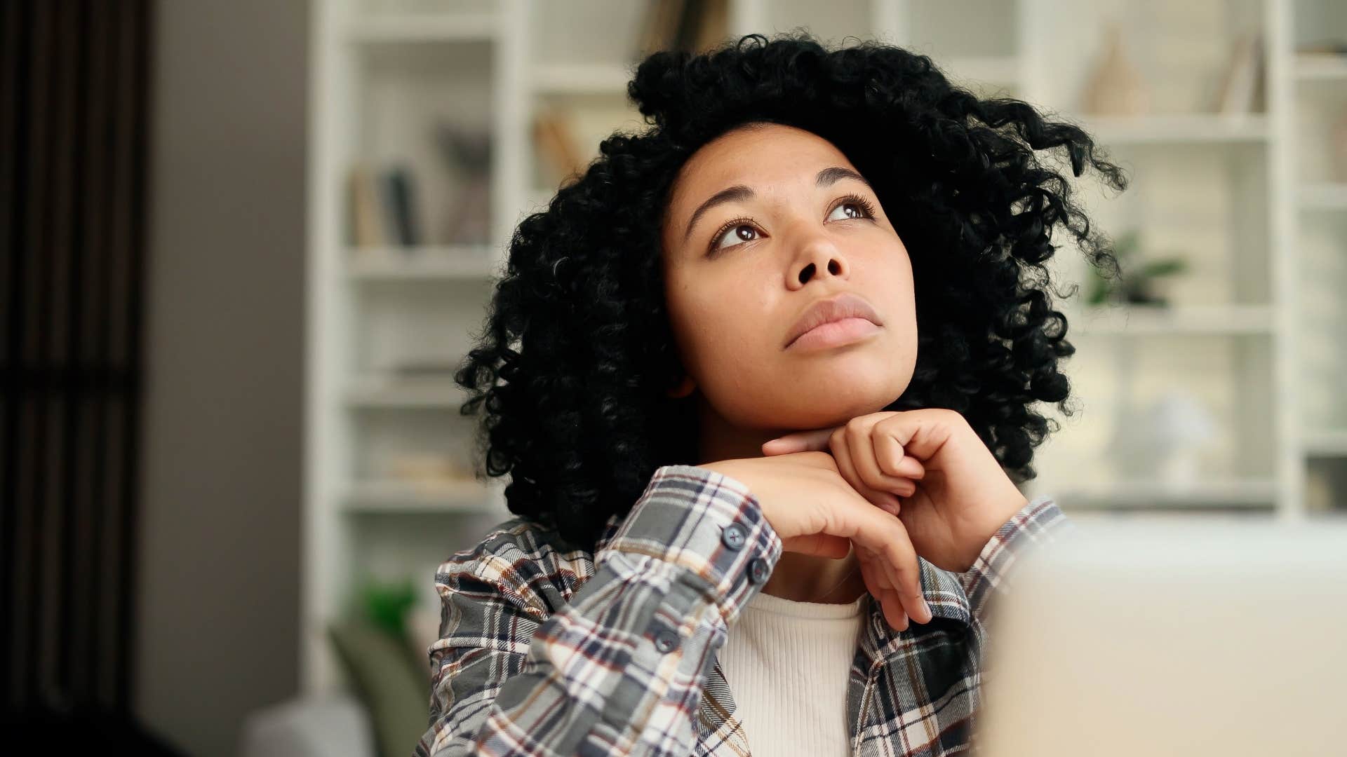 woman in plaid shirt forgetful of the little things as she daydreams