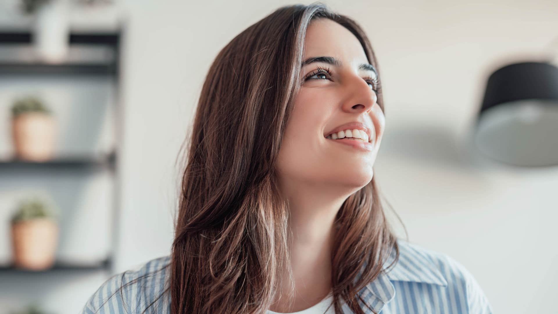 woman smiling and talking to herself while staring up