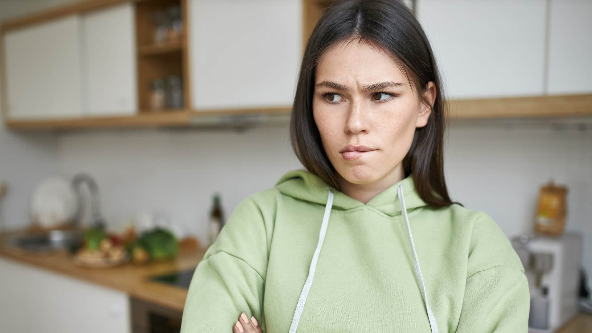 people who refuse to tolerate disrespect & manipulation say these things without thinking twice that doesn't work for me woman in green hoodie looking annoyed while thinking that doesn't work for me