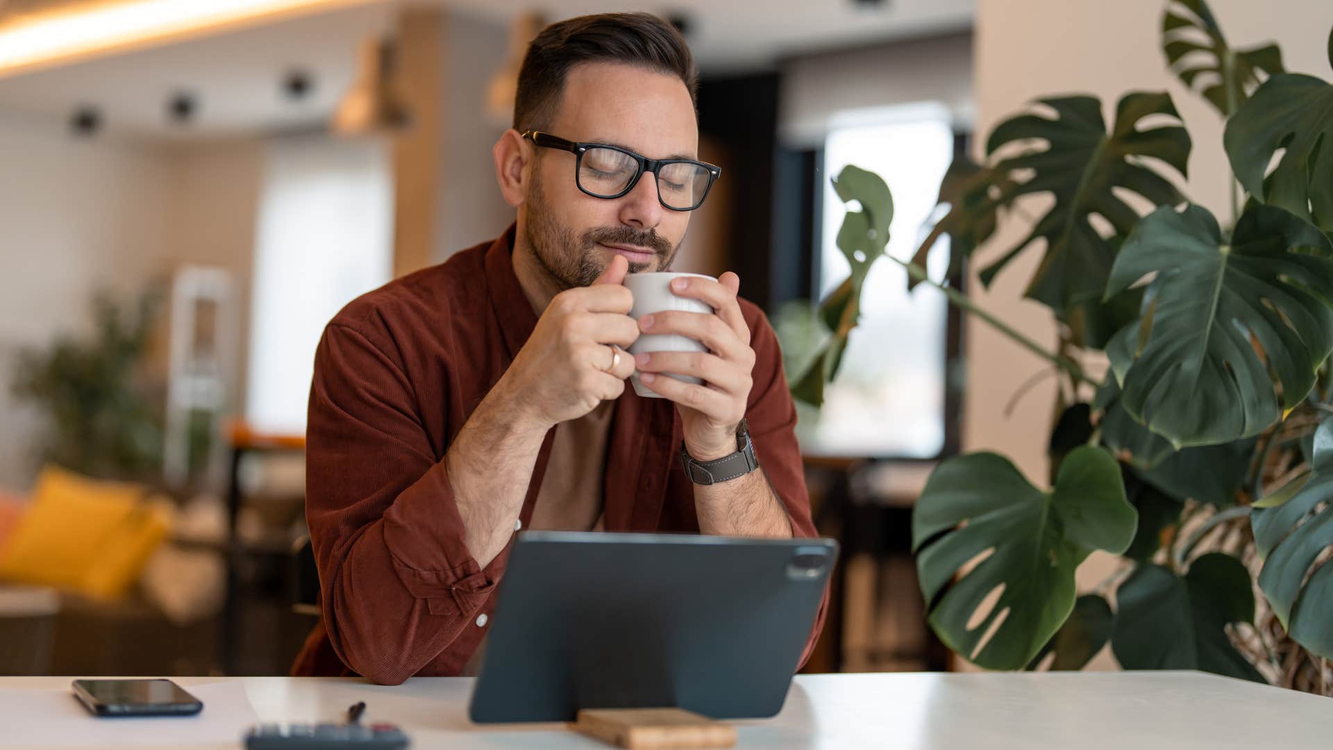man drinking coffee at home