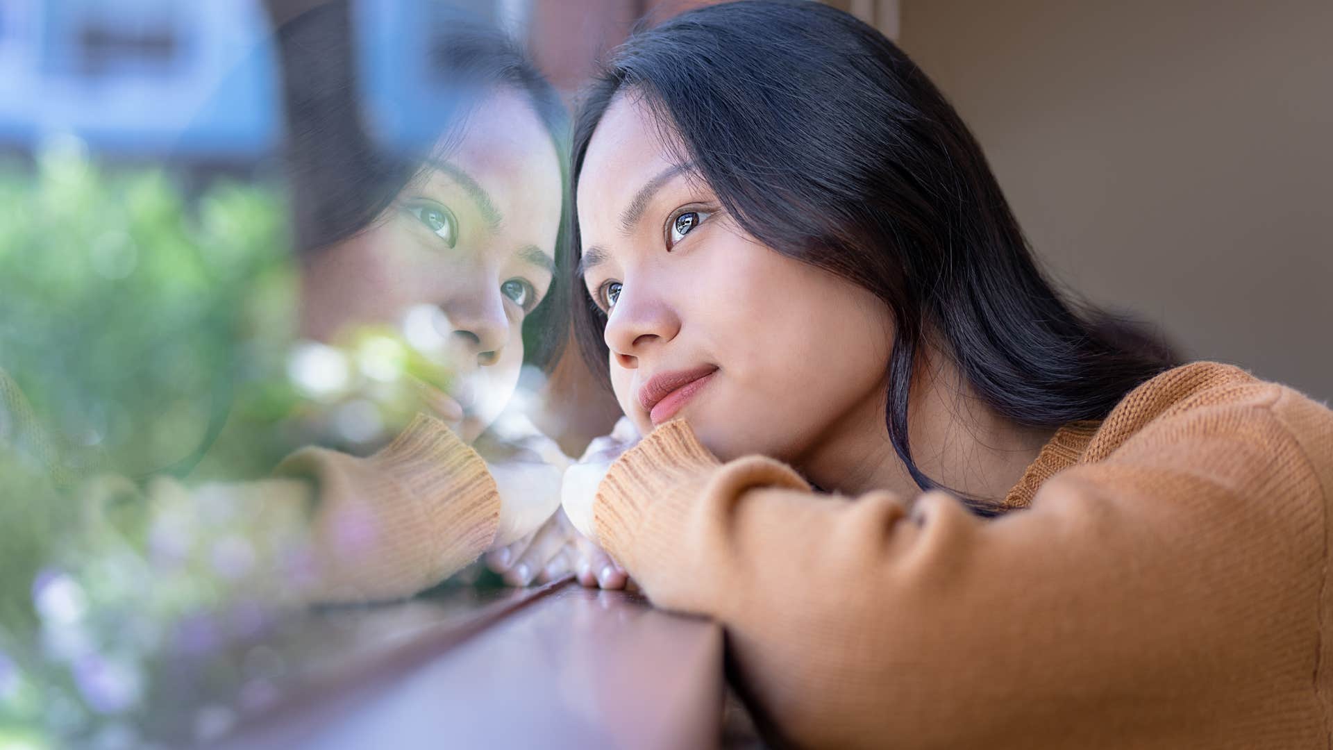 creative woman thinking looking out the window
