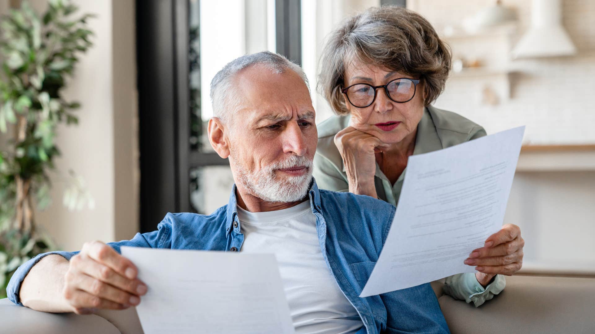 dependable woman looking at bills with her husband
