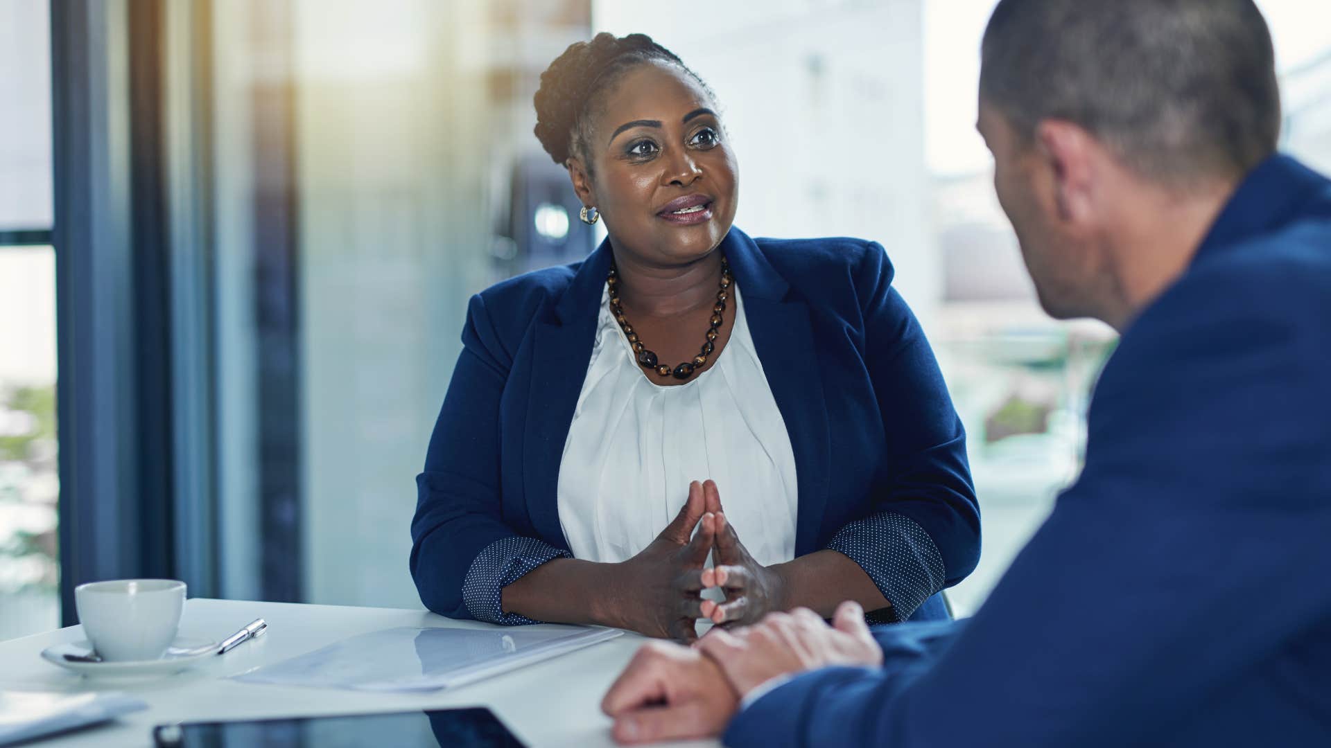 Woman who asks lots of questions talking at work.