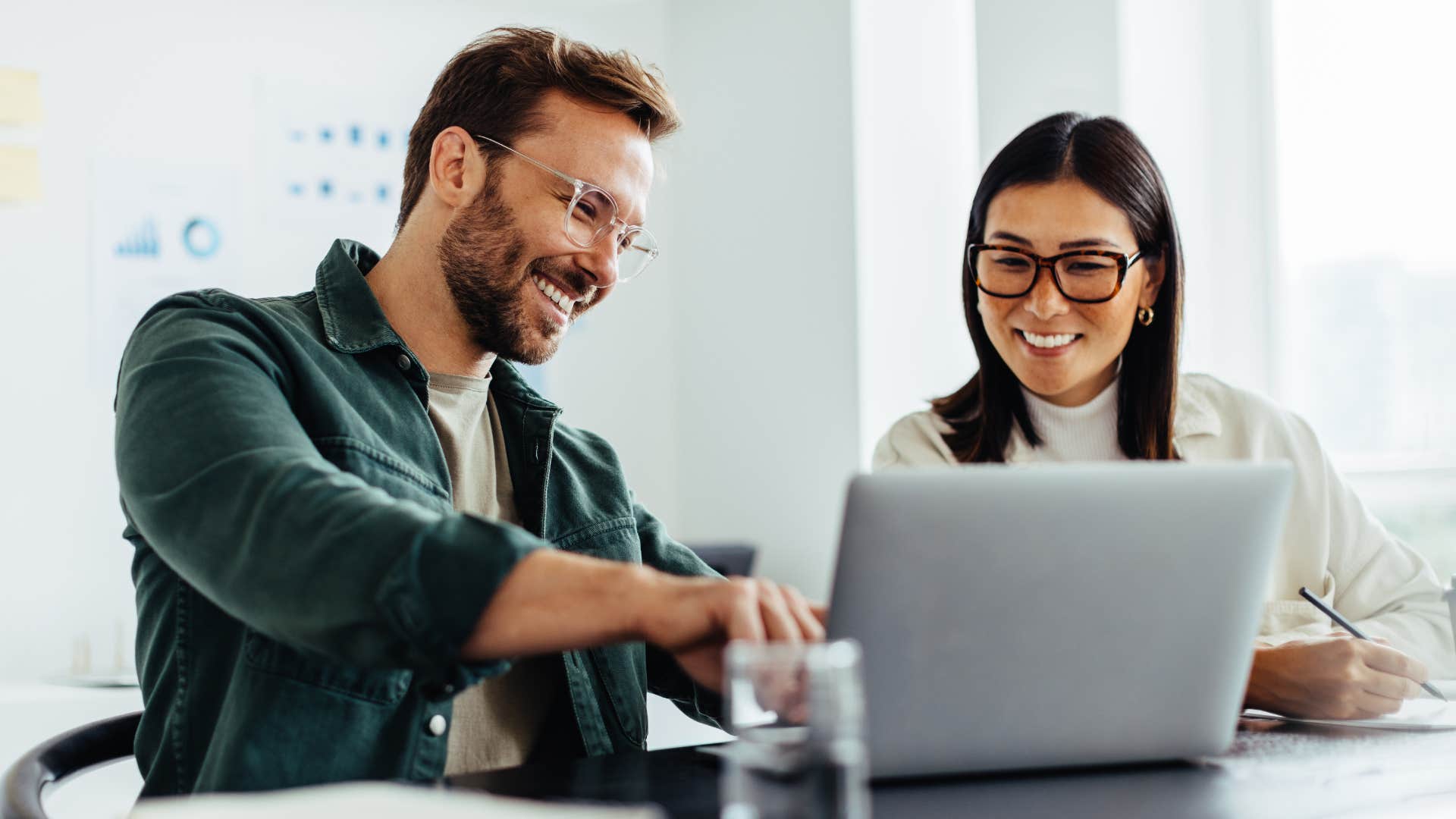 Woman who says yes to challenges smiling at work.