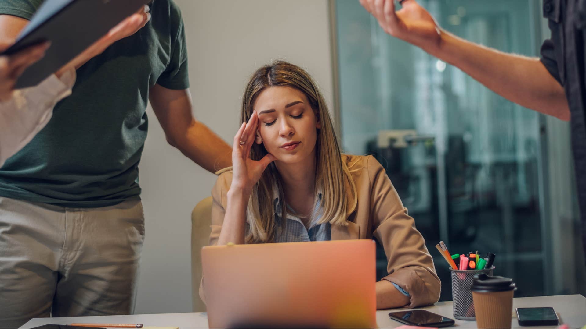 woman feeling exhausted by group settings sitting at work