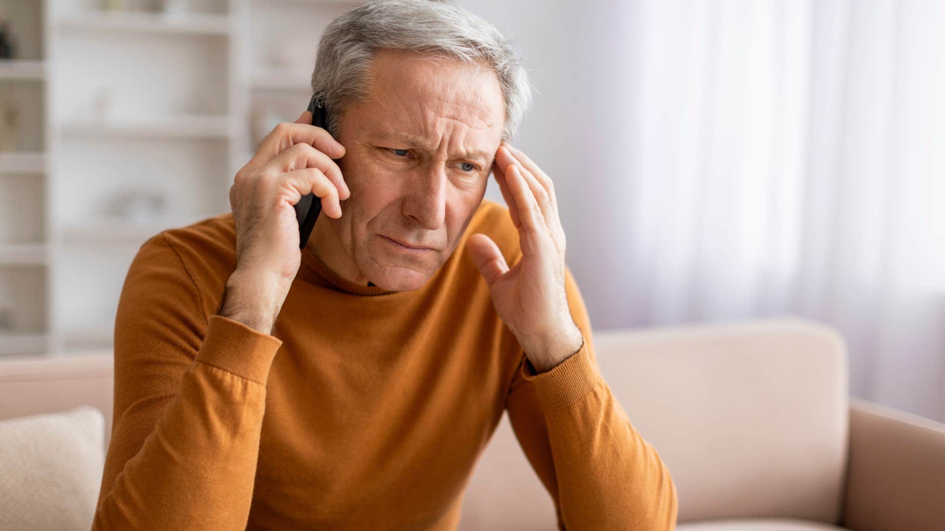pessimistic man talking on the phone