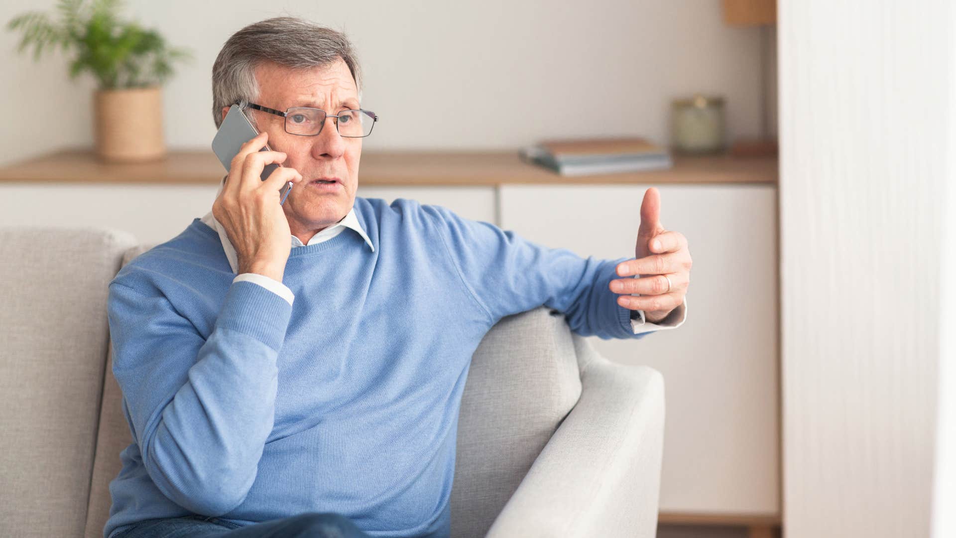 older man talking on phone