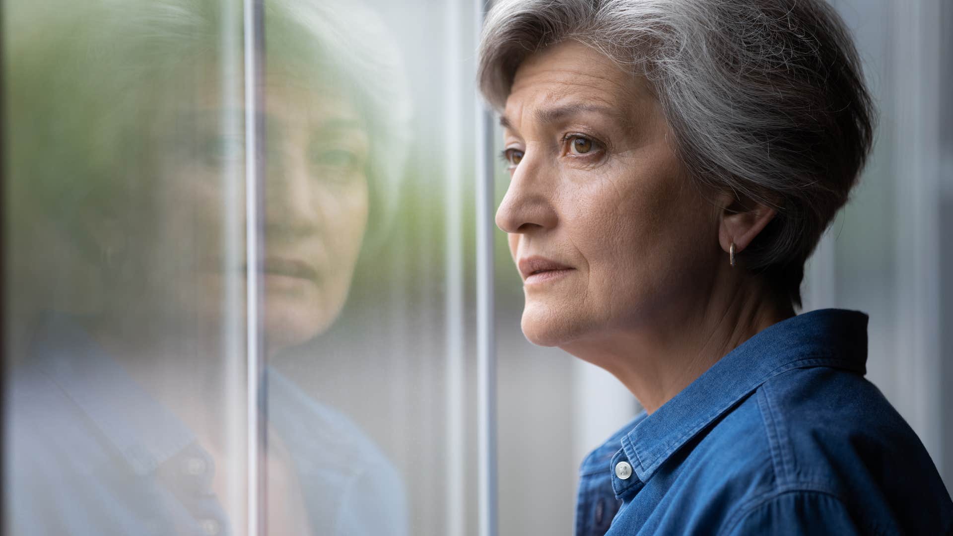 thoughtful woman looking out window