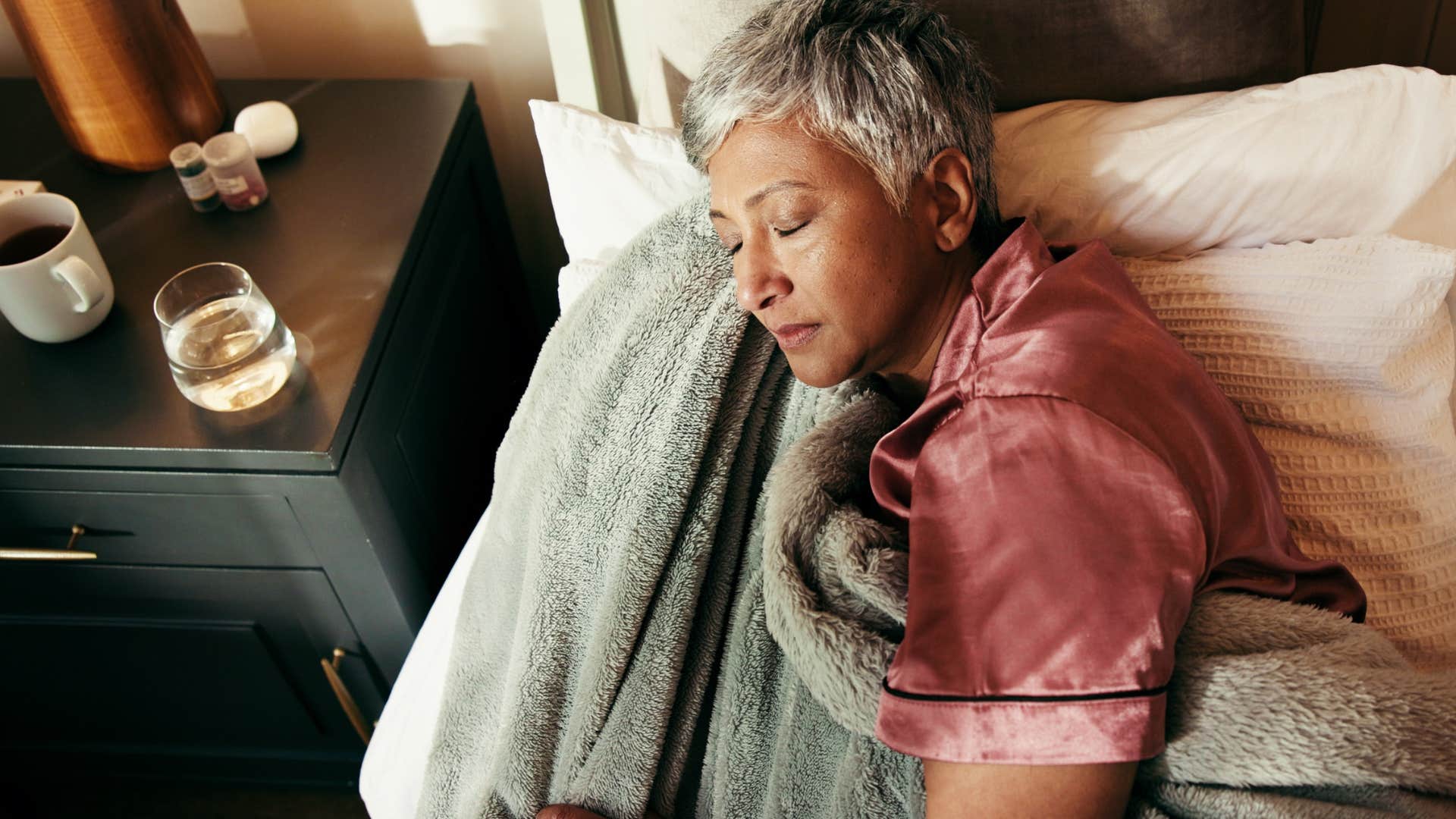 woman sleeping in bed in a way that doesnt restrict her