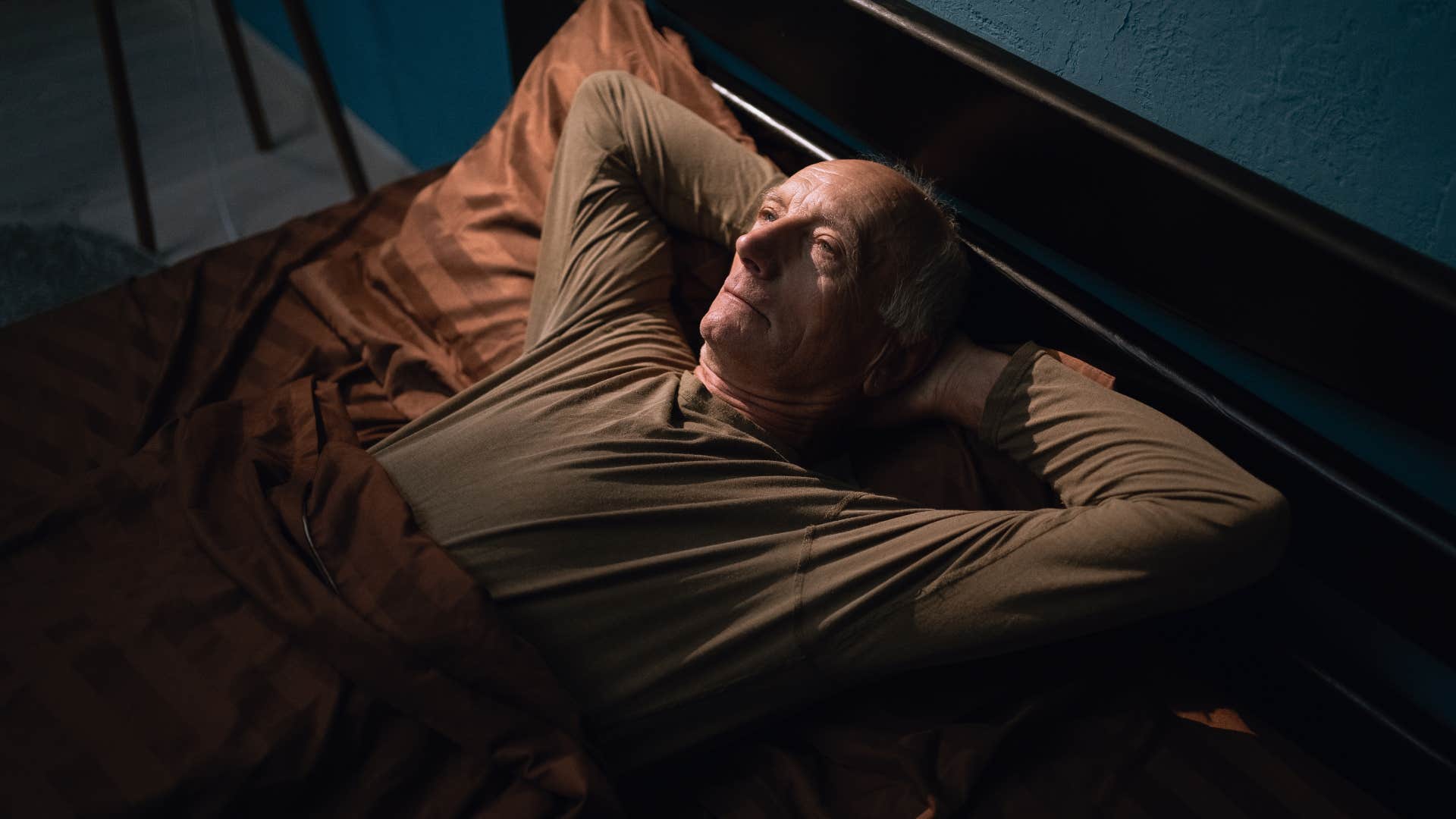 people who can't sleep without a fan blowing in their face usually have these reasons minds prone to wandering at midnight man with a wandering mind awake at night in bed