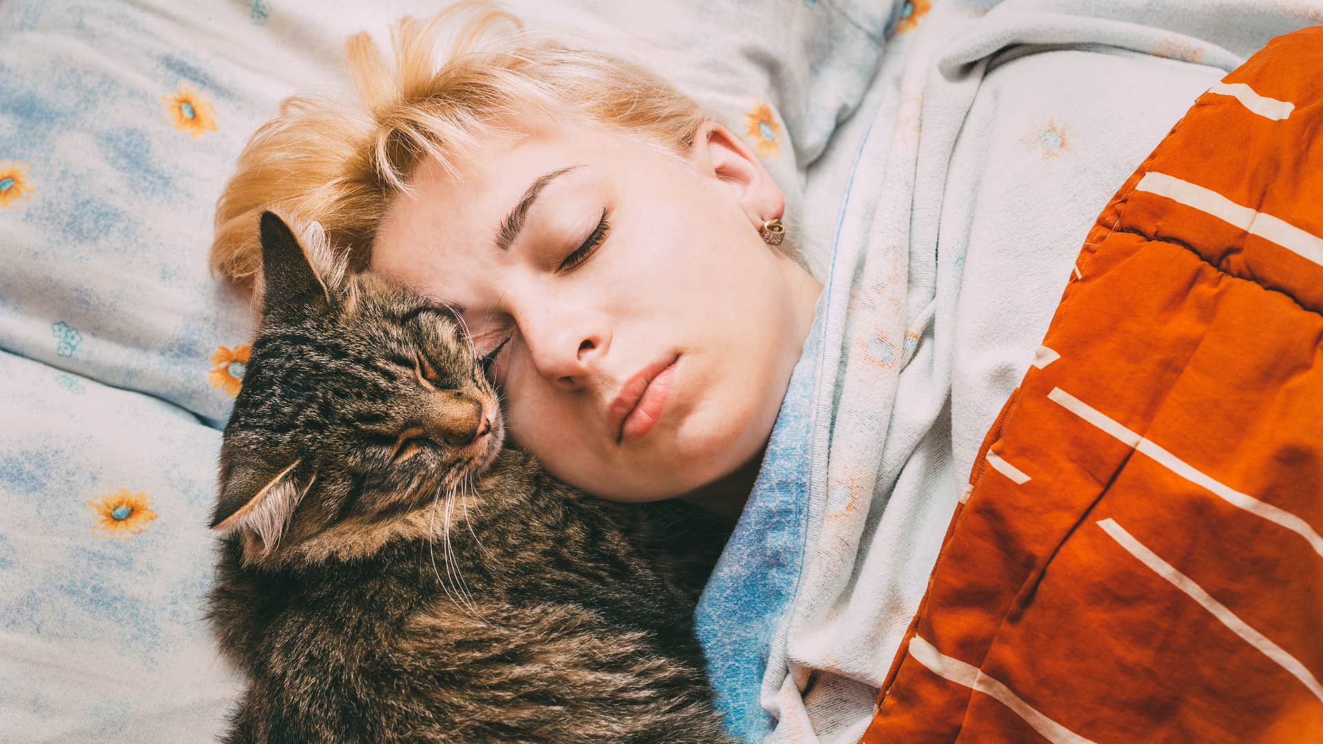 people who can't sleep without a fan blowing in their face usually have these reasons signal for others woman sleeping soundly next to her cat