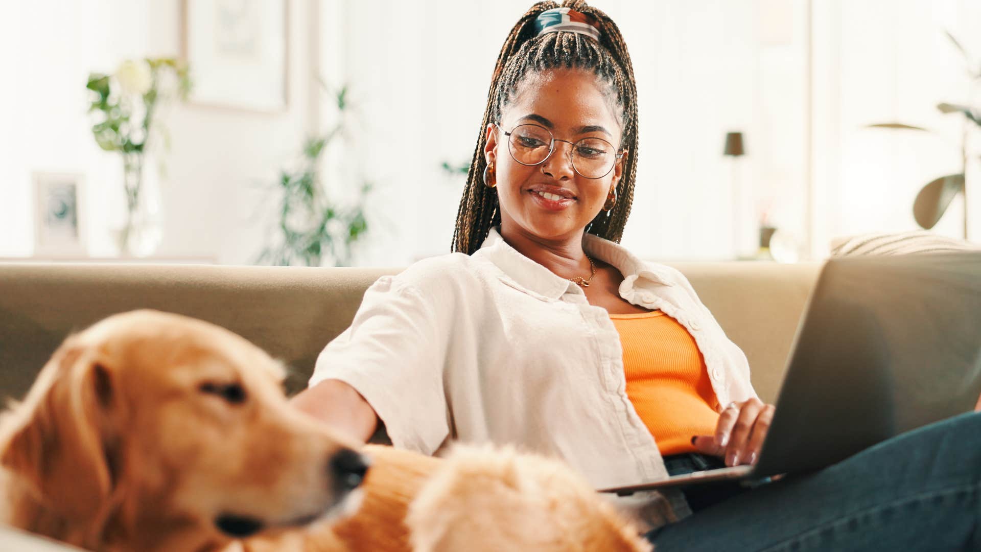 Woman who wants to monitor their pet smiling at home.
