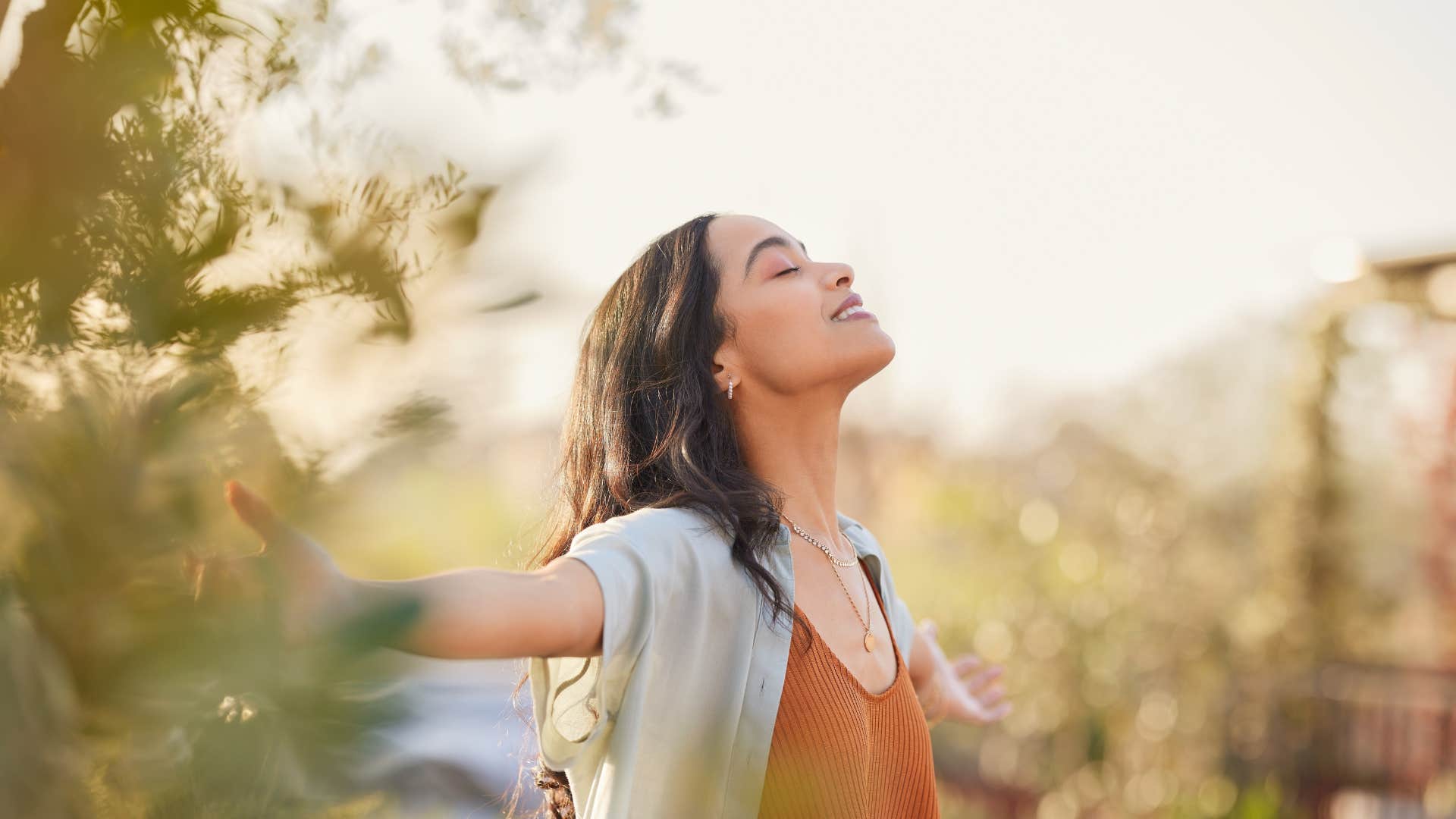 woman outside deep breathing and being mindful of her routine