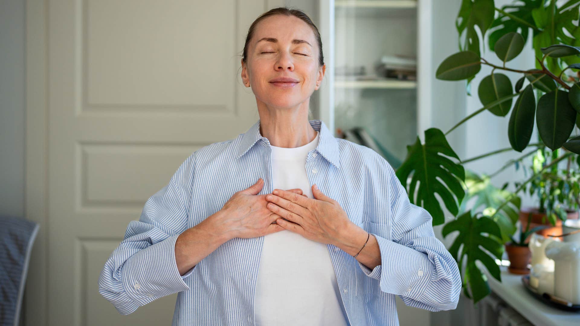 deeply spiritual woman meditating alone at home