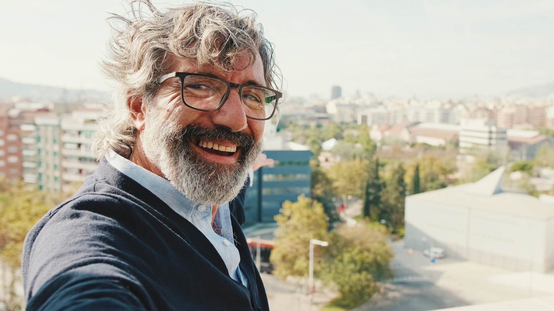 man who has high standards smiling standing outside