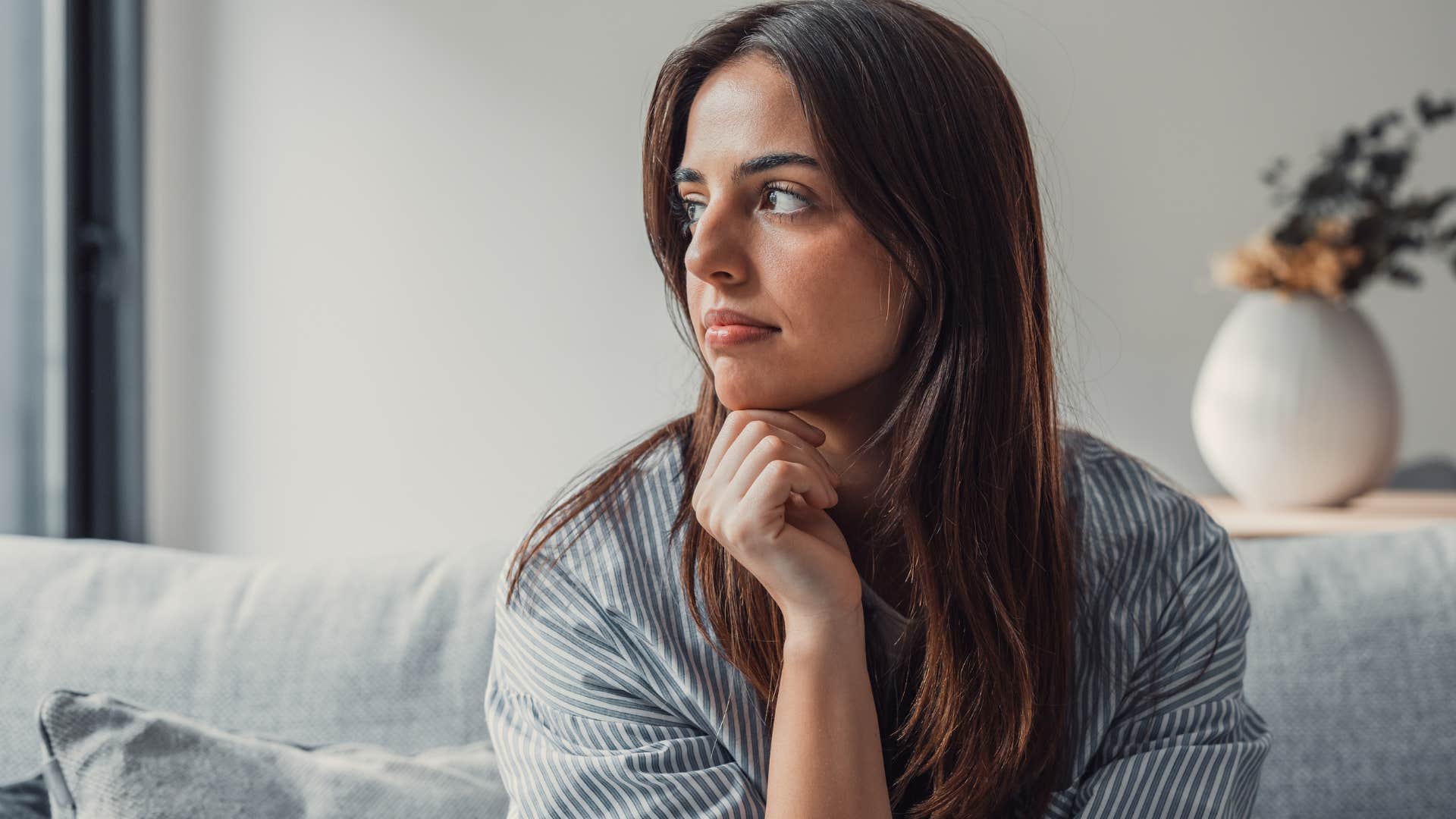 introverted woman sitting at home alone