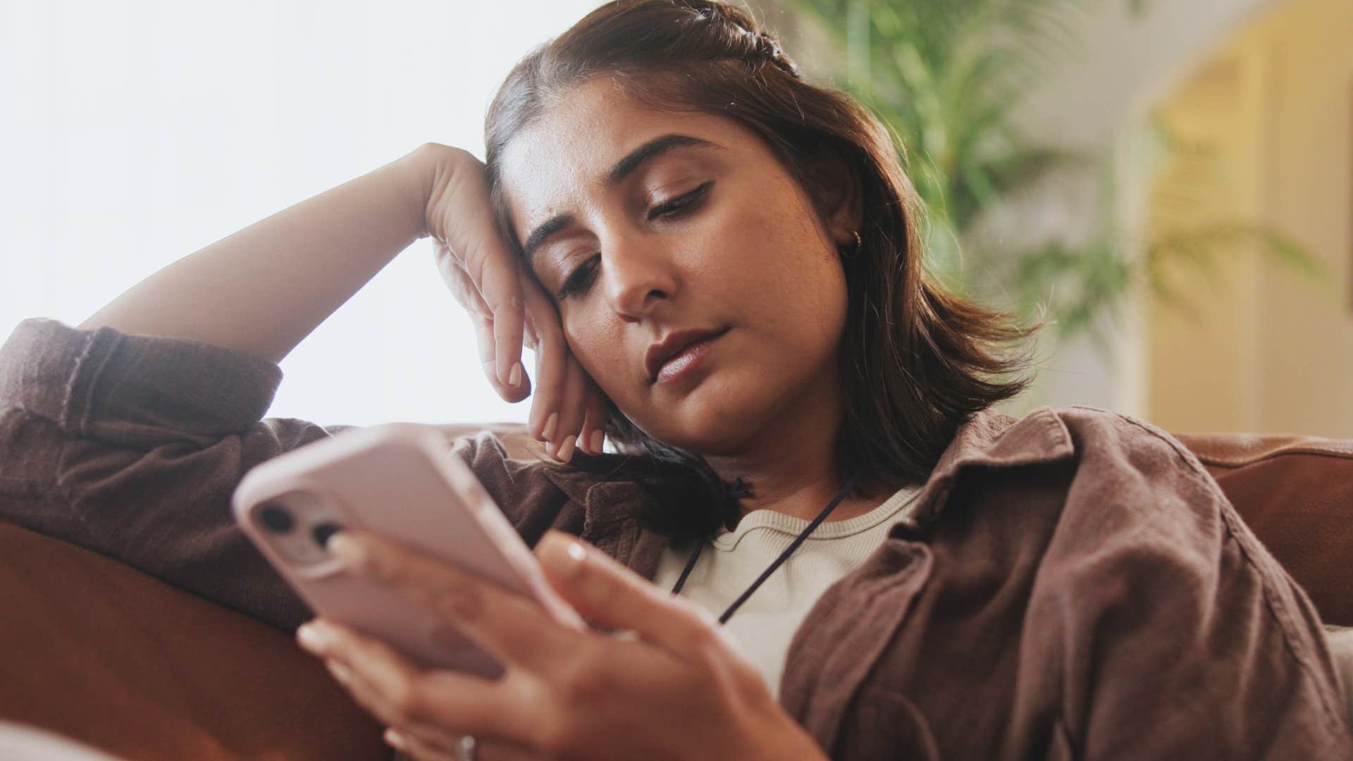 Woman texting "I think we're going to keep things quiet tonight" on her phone.