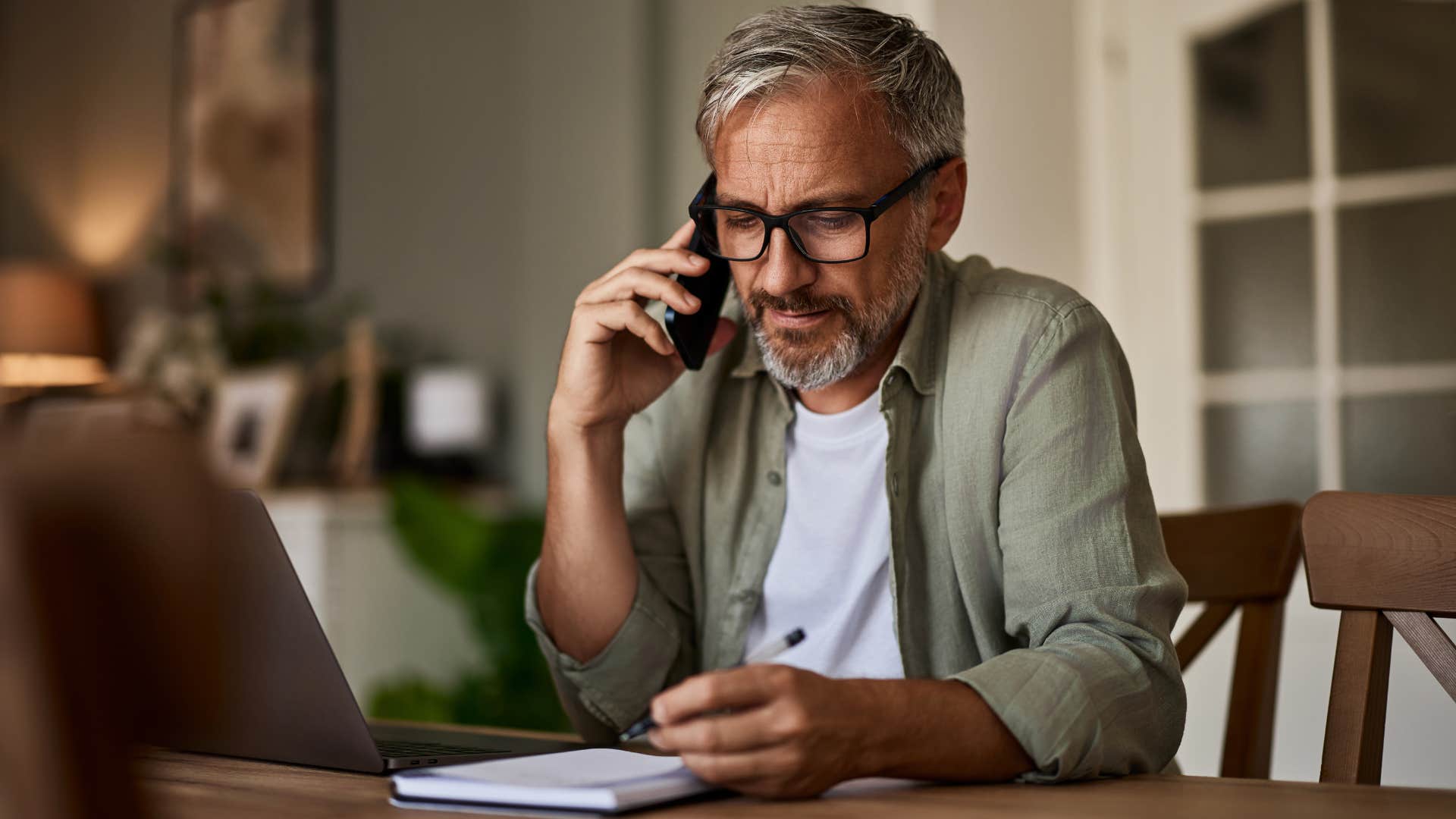 Man saying "I'd love to see you, but could we do it here instead?" on his phone.