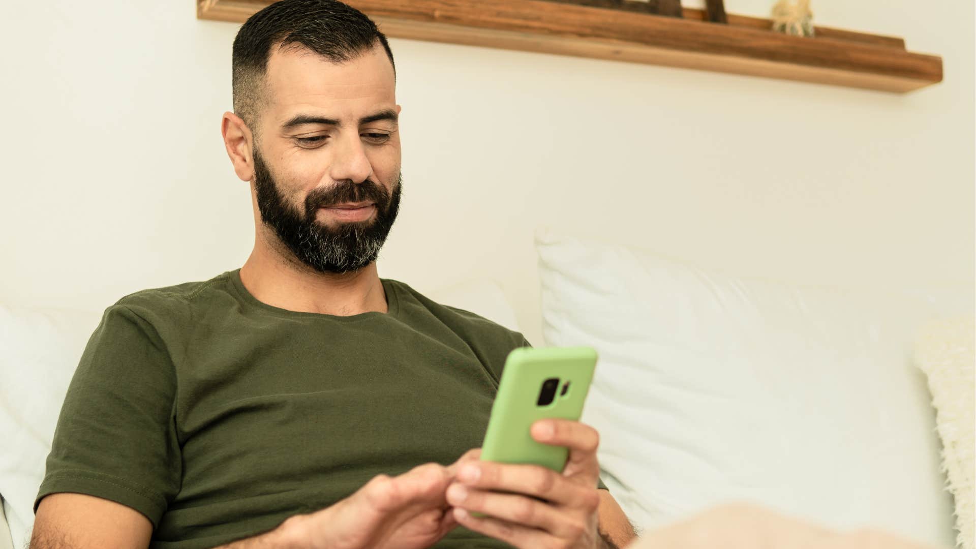 Man texting "I'm not feeling well, maybe another time?" on his phone.