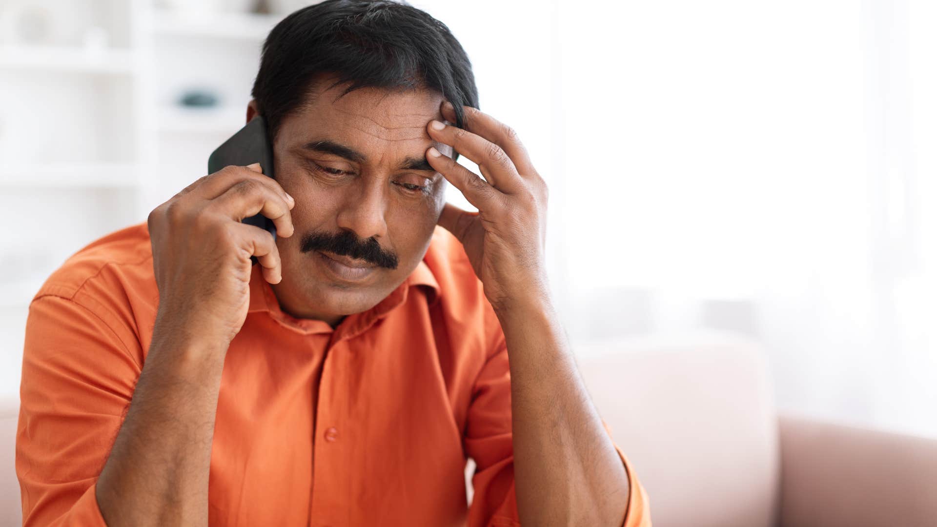 Man saying "our schedules are crazy right now, so I can't fully commit" on the phone.