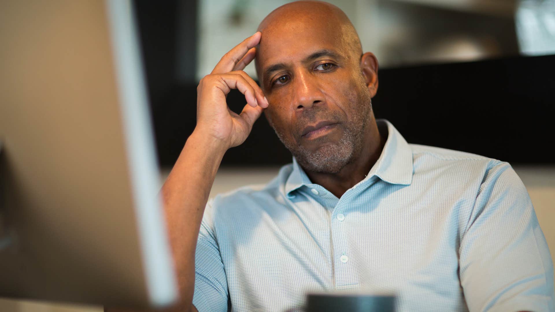 Man who's a people-pleaser sitting at work.
