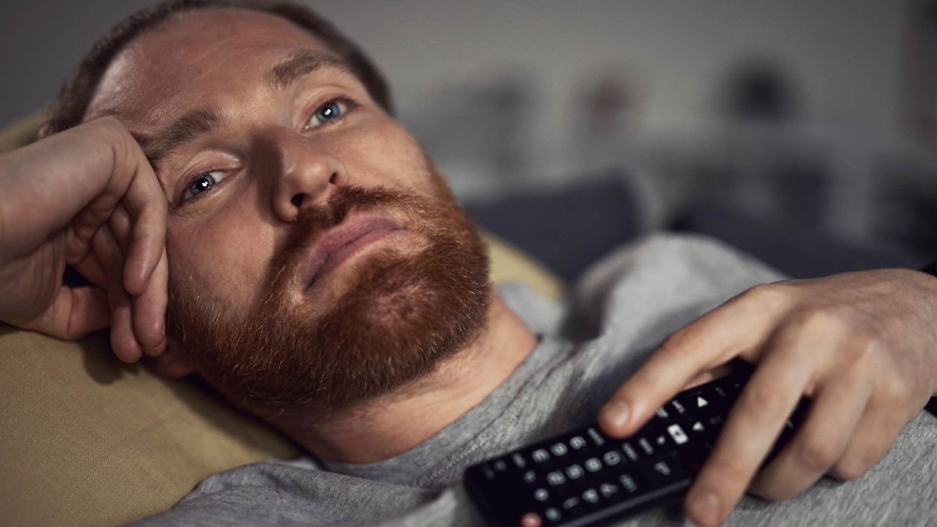 Man going to bed earlier or staying up later at home.