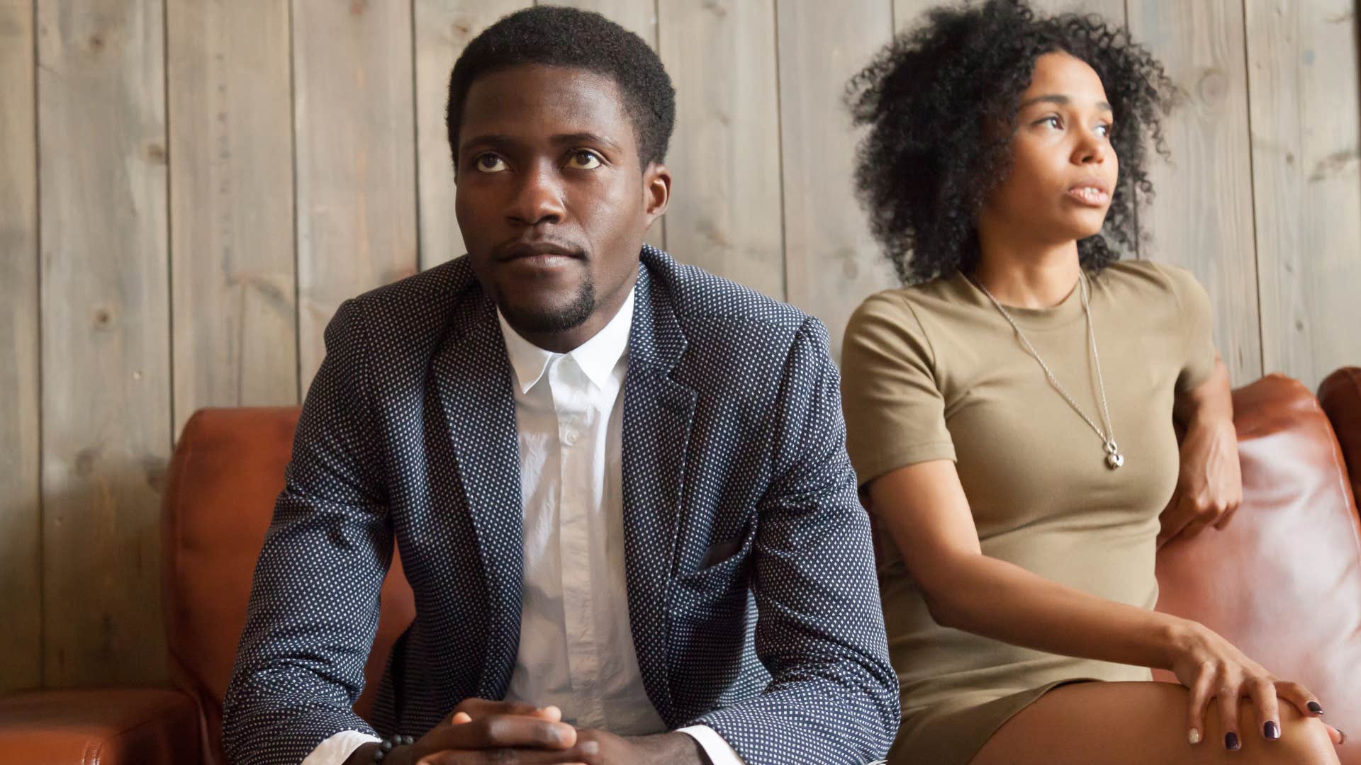 Man who's not making eye contact anymore looking away from his wife.