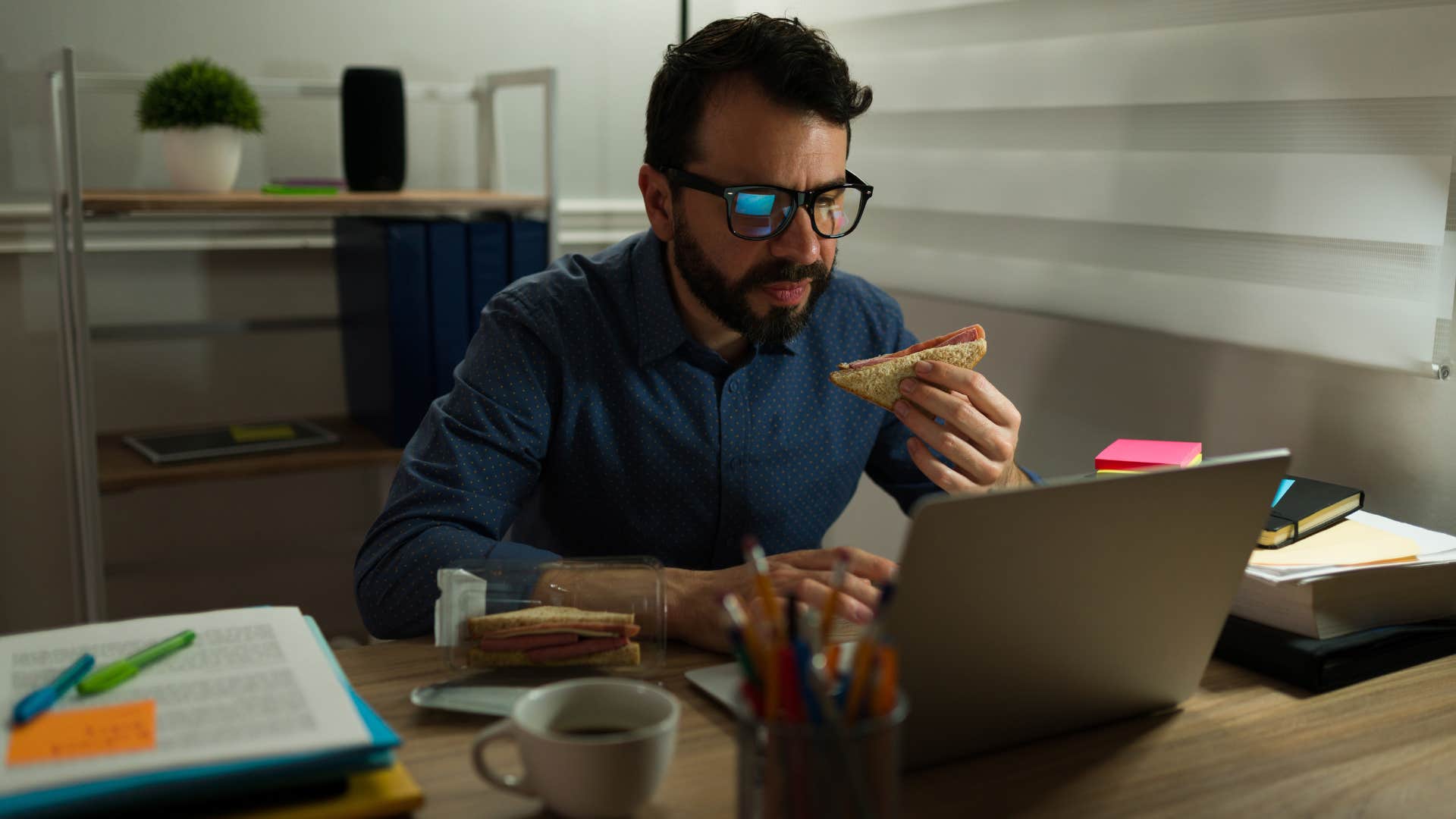 Man overworking themselves at home on their laptop.