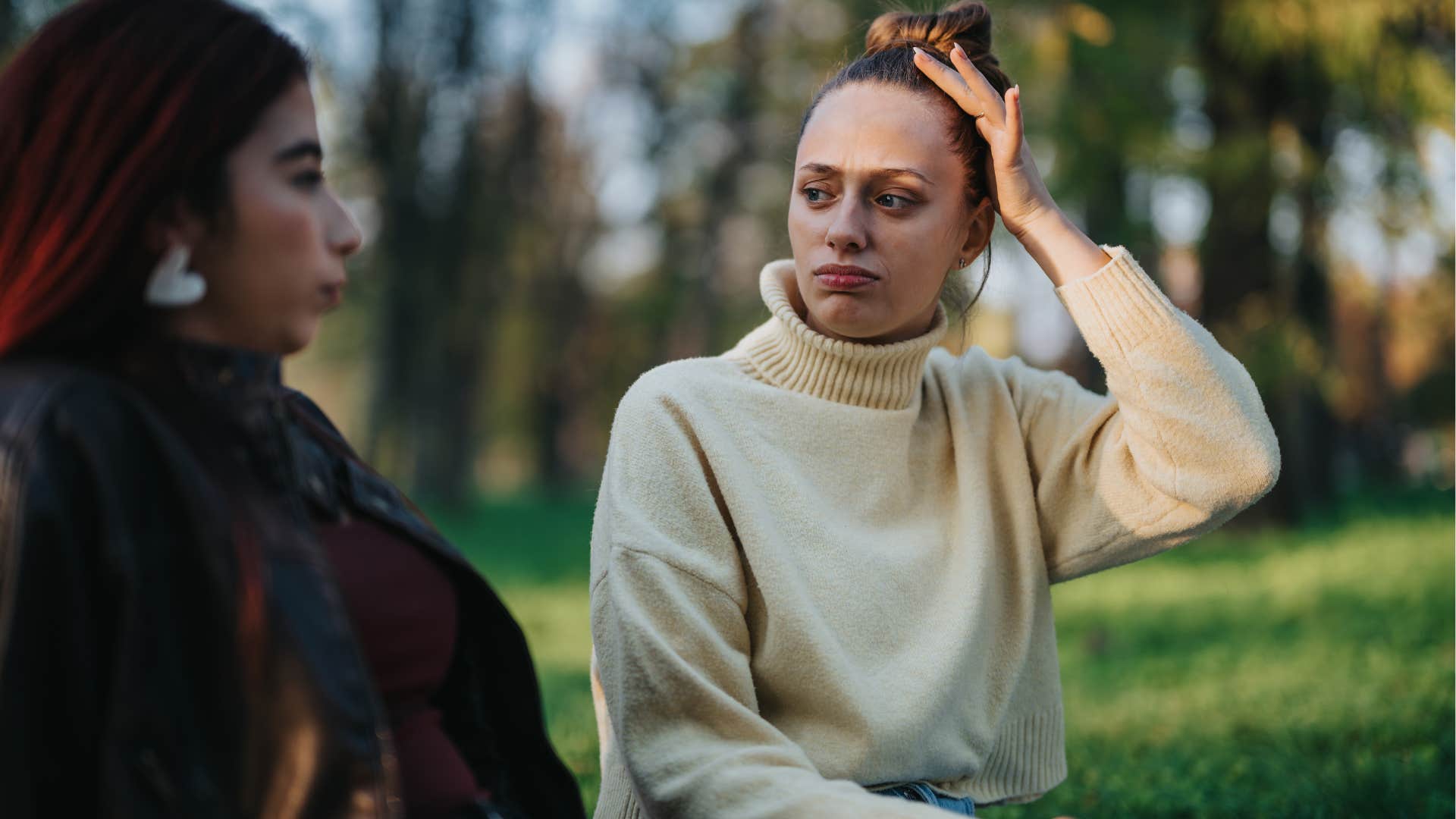 embarrassed woman fidgeting with her hair and clothes