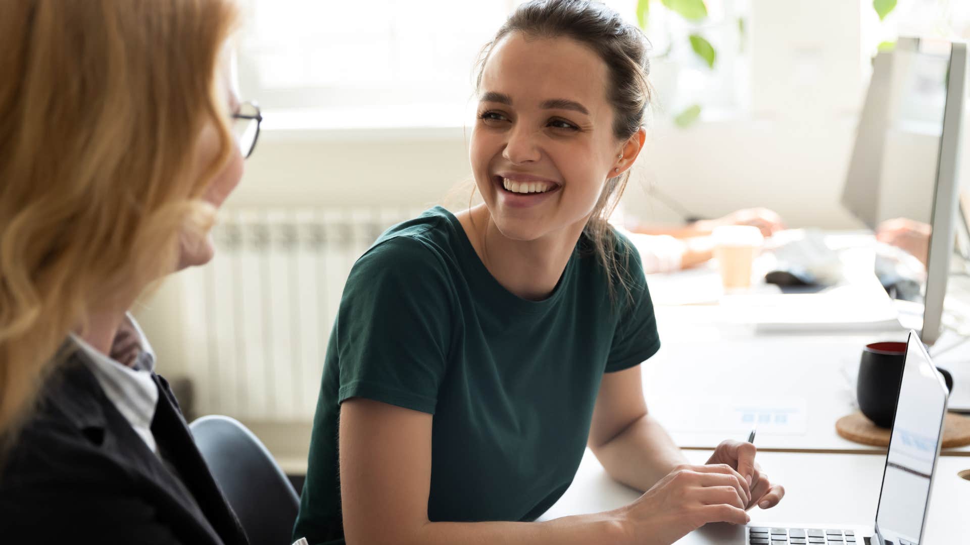 woman pretending to be unfazed while talking to a friend