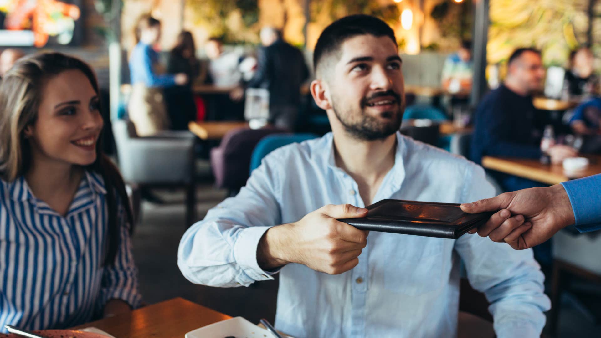 man paying bill at restaurant