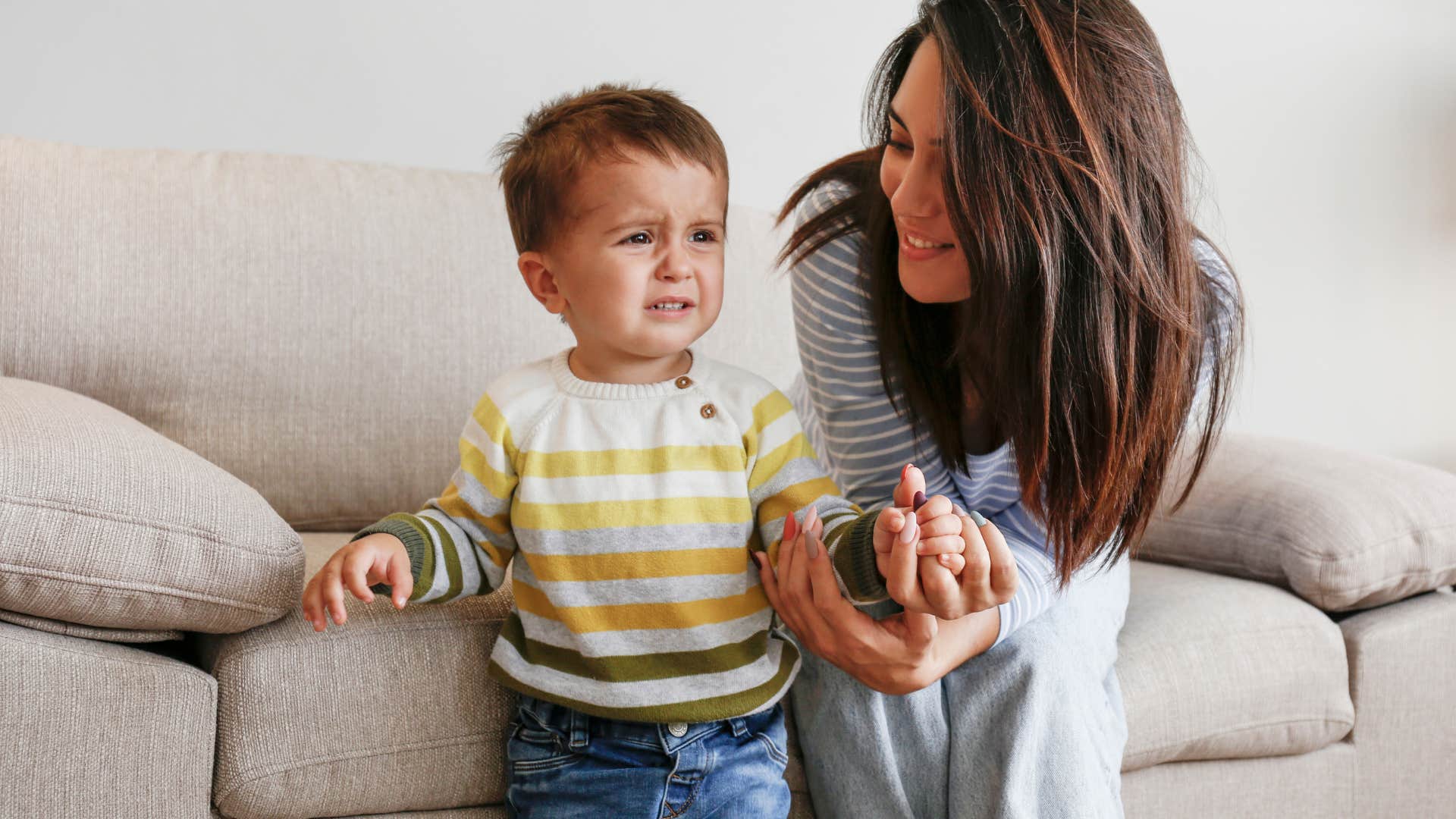 mom giving in to toddler throwing tantrum