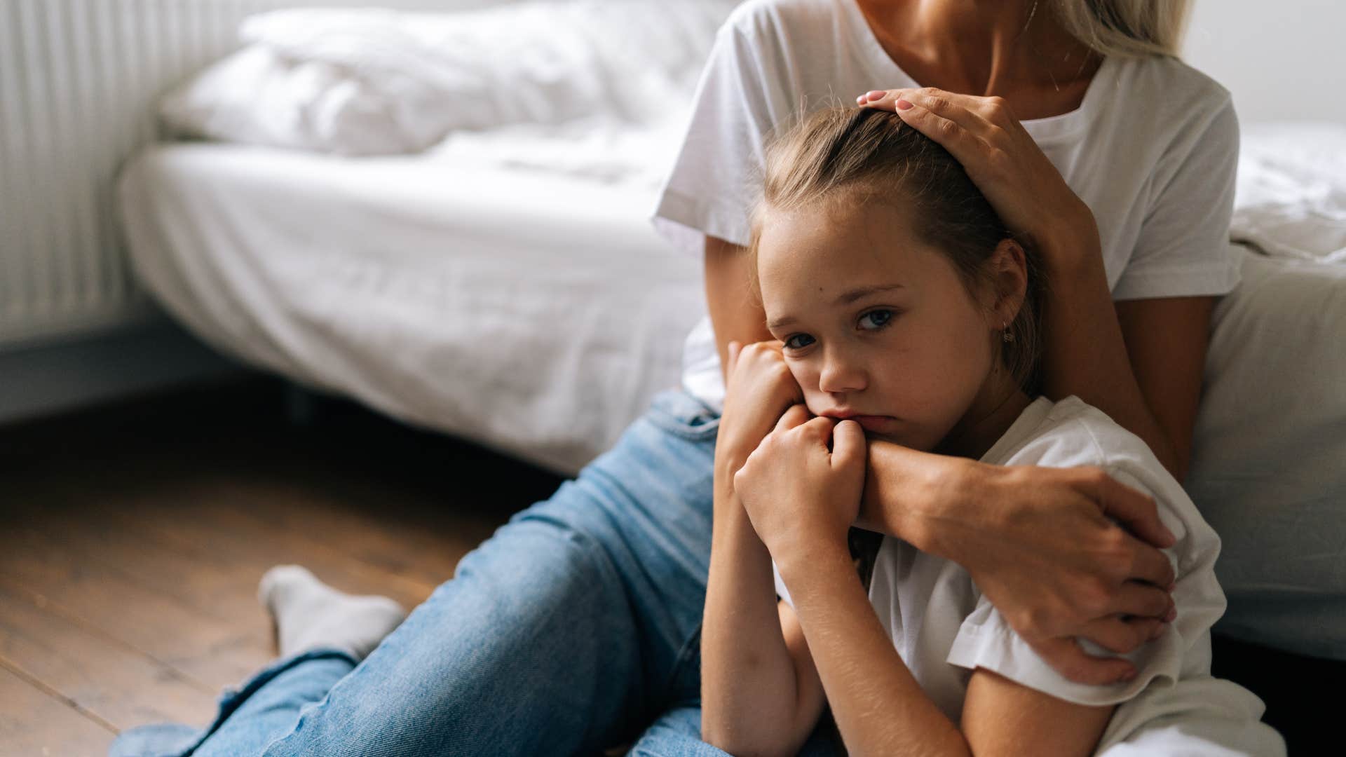 mom comforting upset daughter