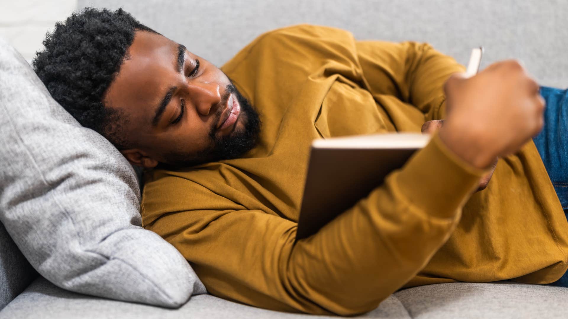 man avoiding drama reading a book at home