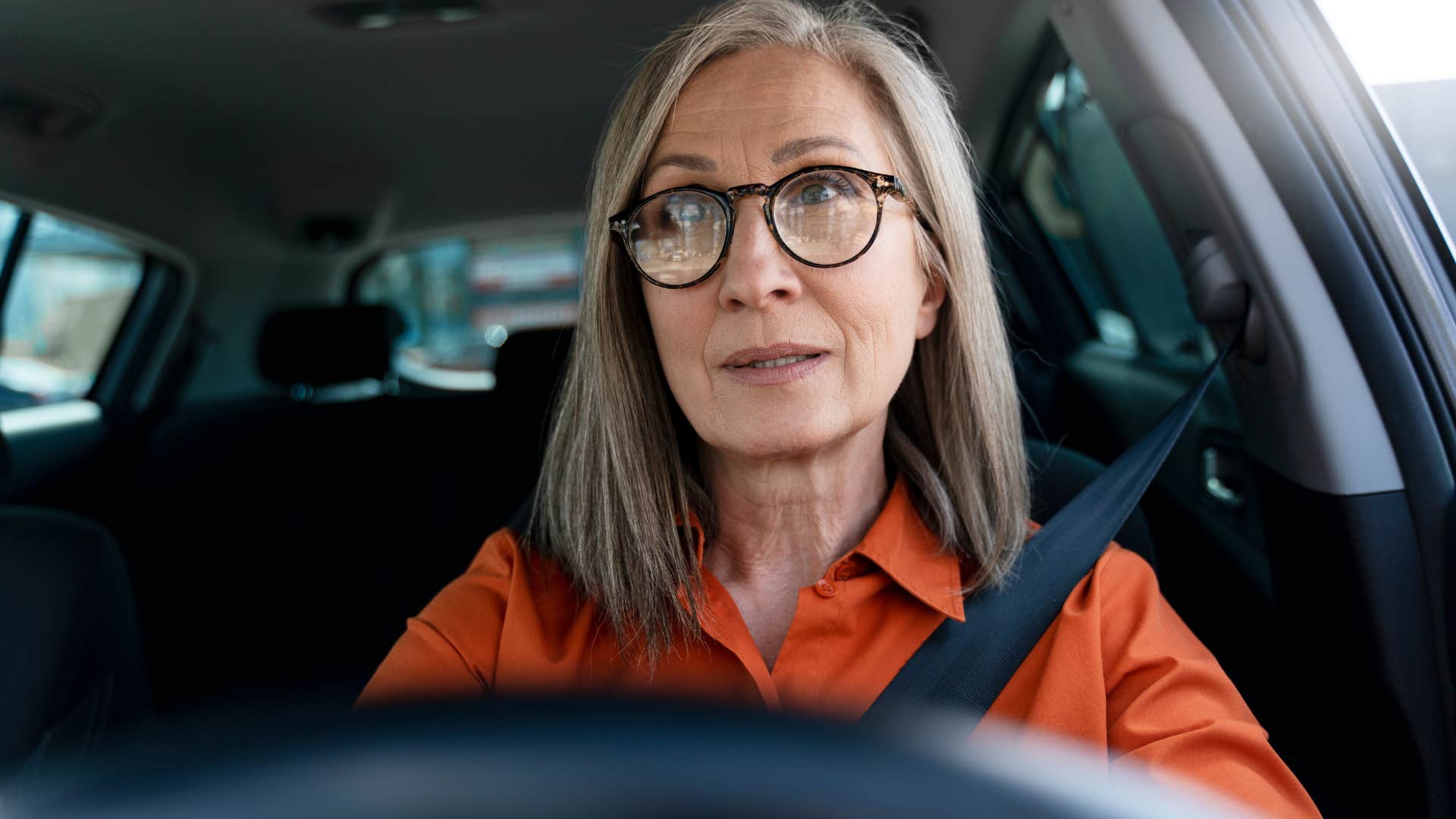 burnt out woman driving her car