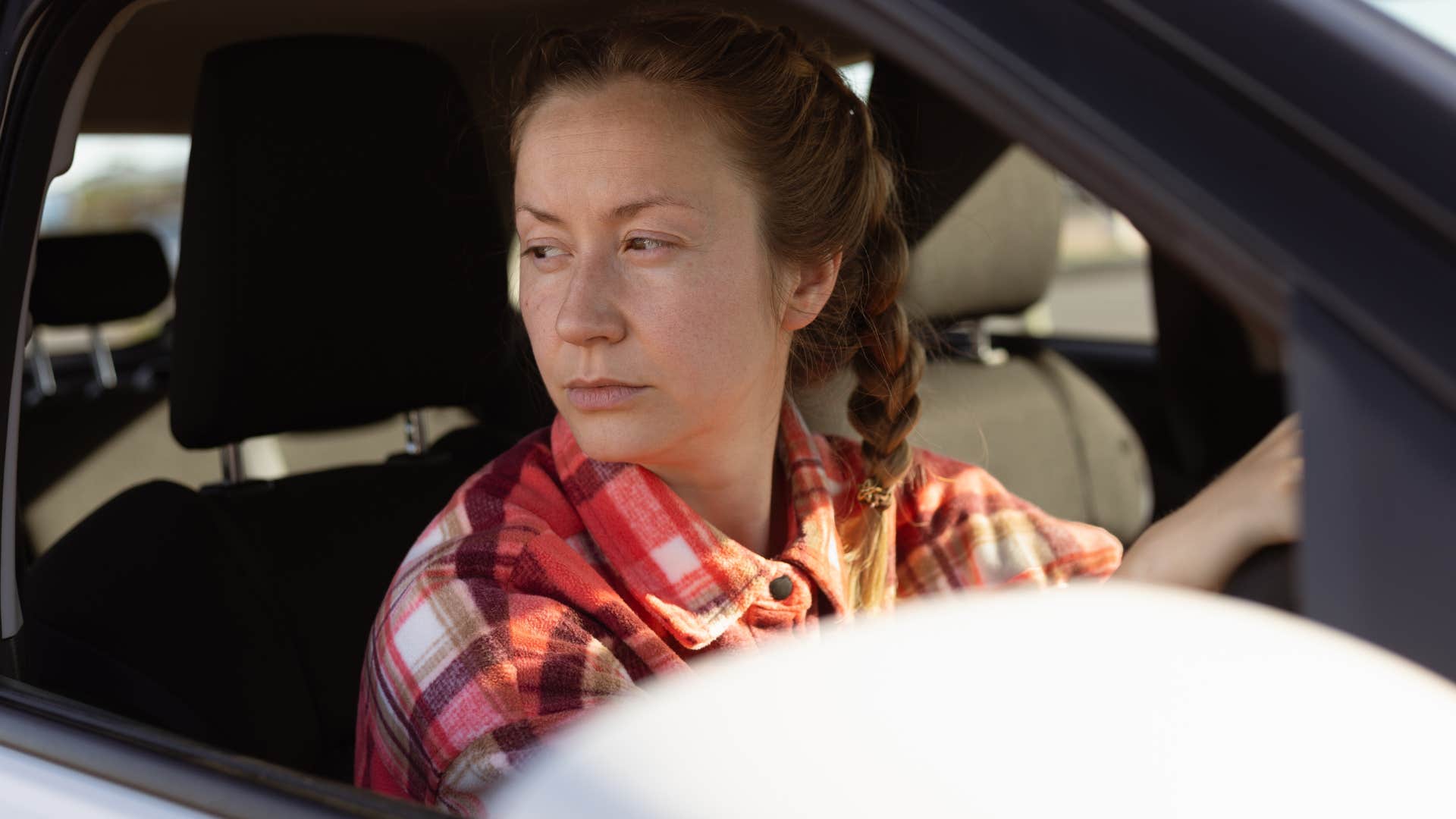 woman who values convenience over everything sitting in her car