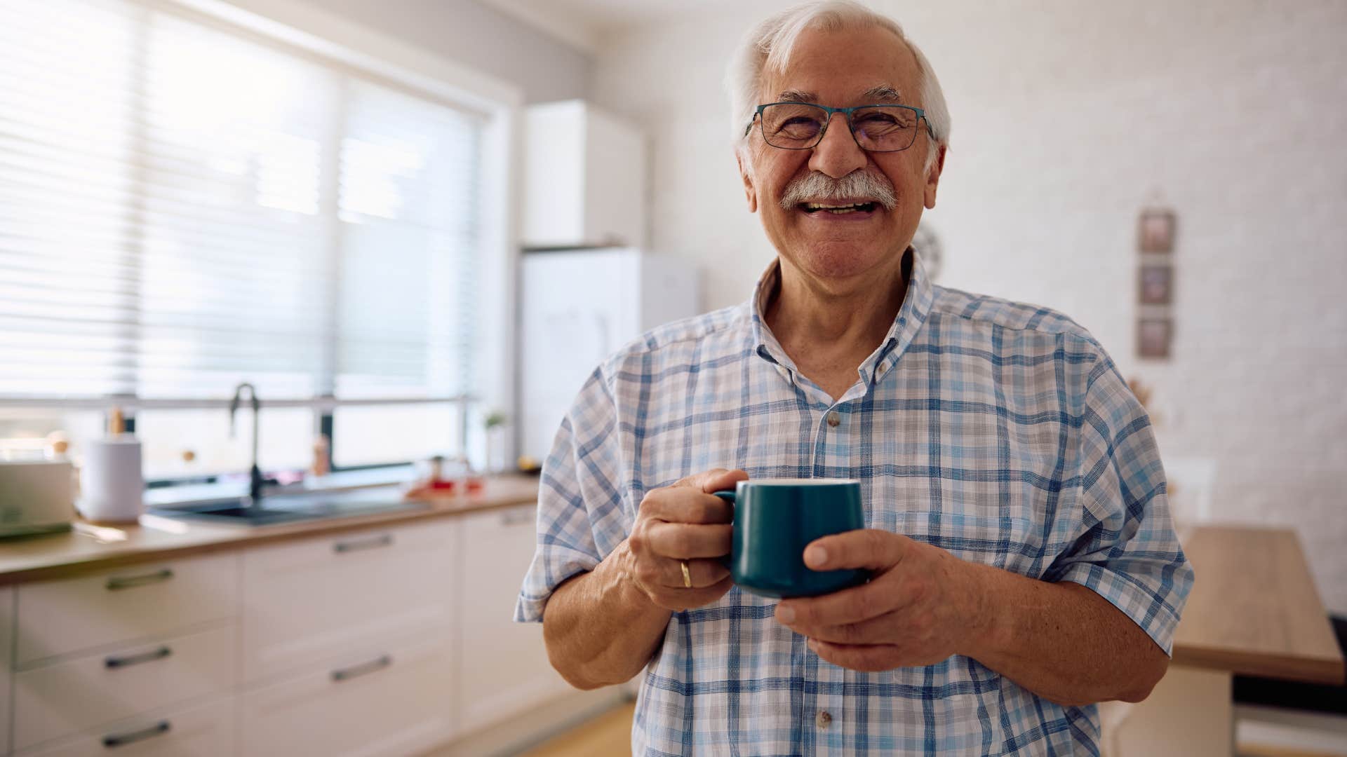 mindful people who prefer tea over coffee usually have these surprisingly grounded personality traits Mindful man drinking tea at home.