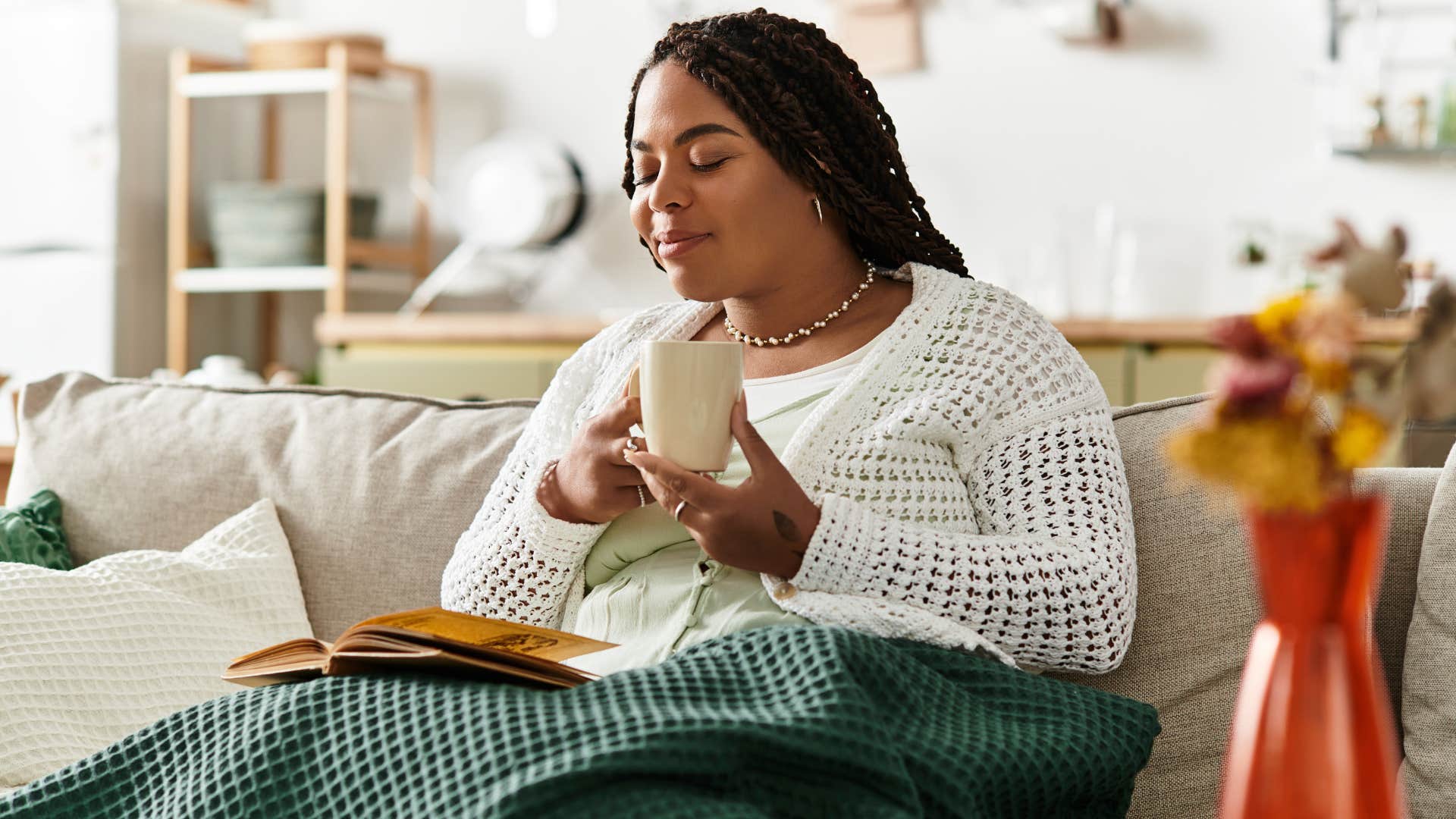 perform best when relaxed people who prefer tea over coffee usually have these surprisingly grounded personality traits Woman who performs best when she's relaxed sitting on her couch.
