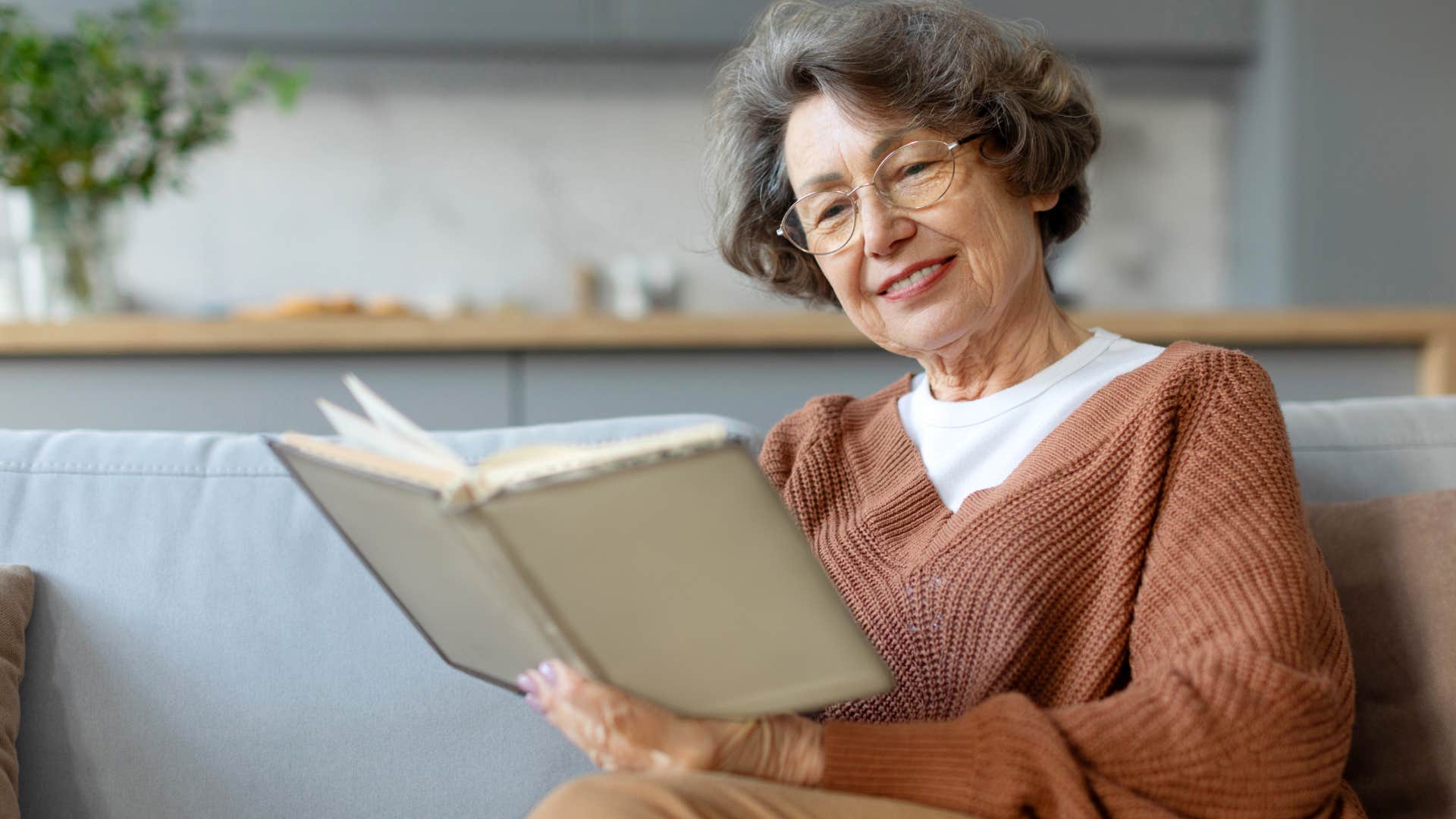 happy woman who loves reading for hours holding a book