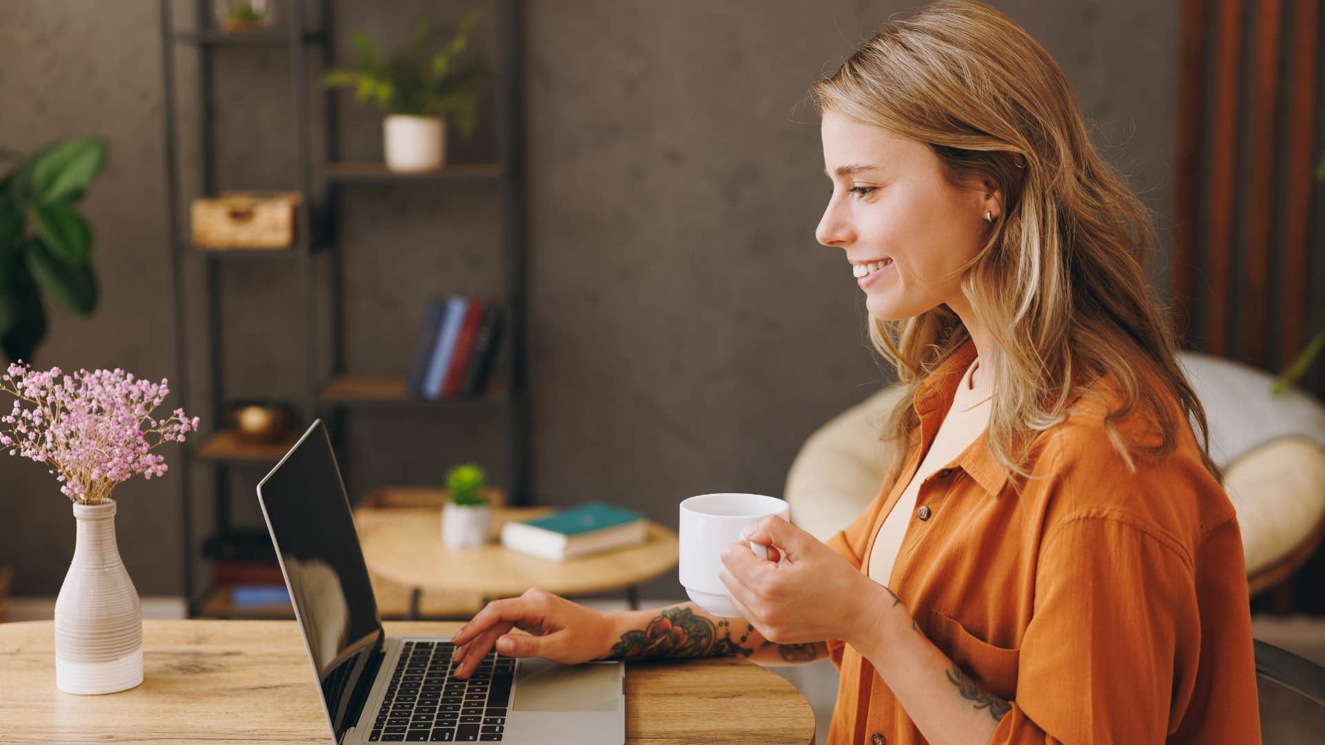 woman sitting alone in a cafe and smiling