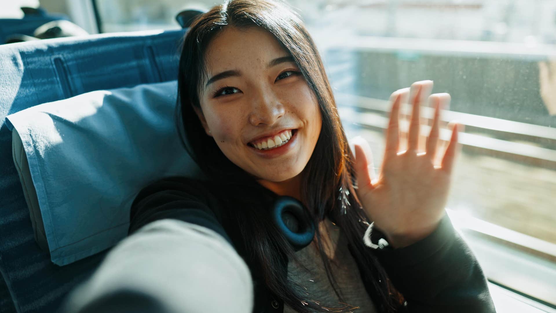 woman smiling taking a selfie while solo traveling