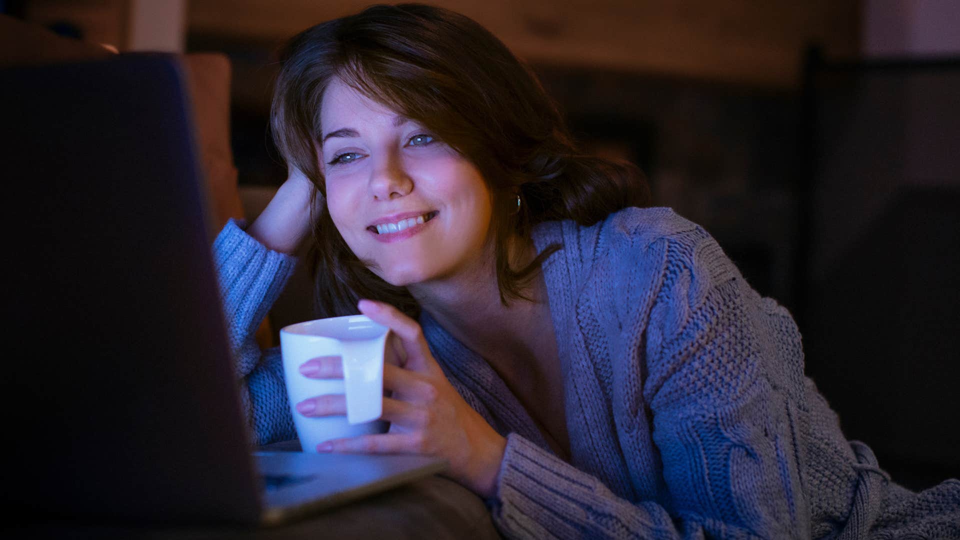 happy woman watching comfort movies and shows at home