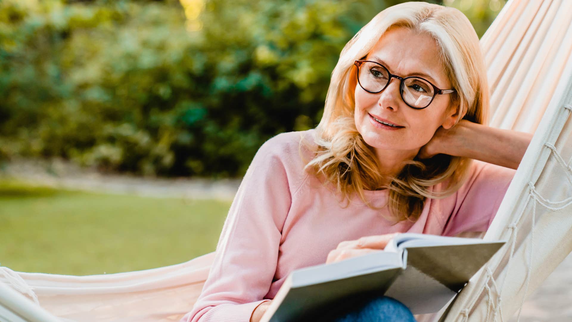 deeply present people who still read physical books instead of scrolling usually have these rare personality traits deeply present woman reading in a hammock