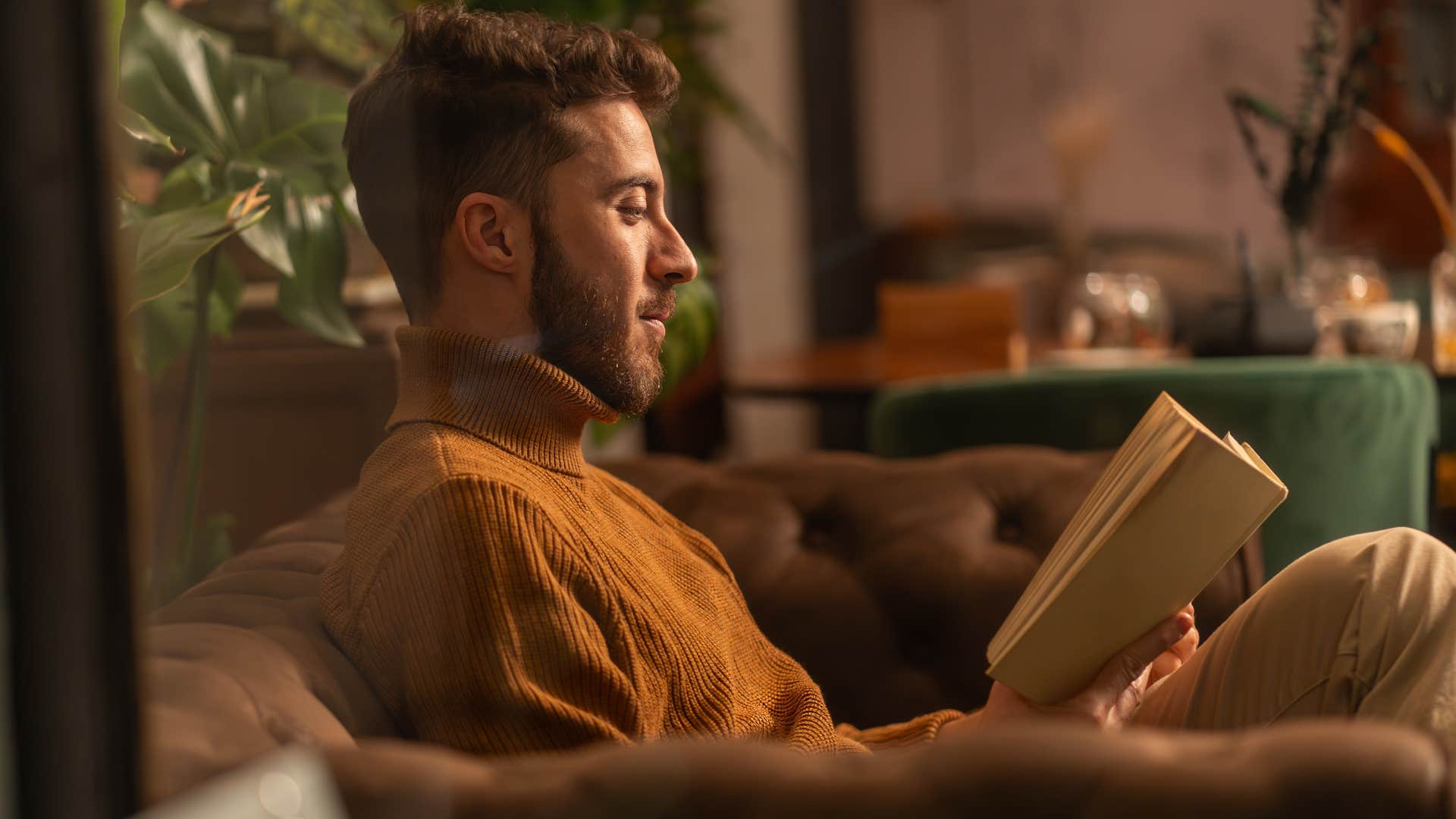 imaginative people who still read physical books instead of scrolling usually have these rare personality traits imaginative man reading a physical book at home