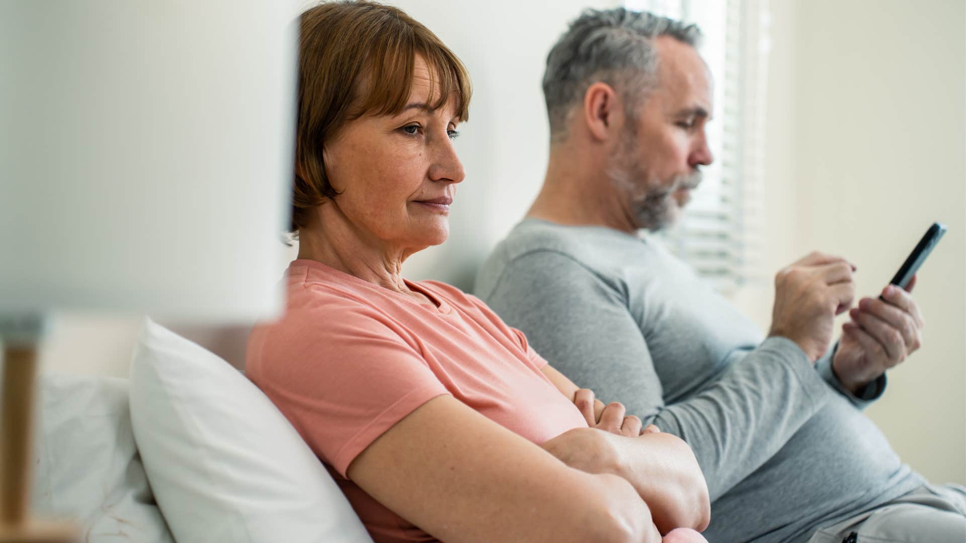 Difficult man ignoring his wife at home.