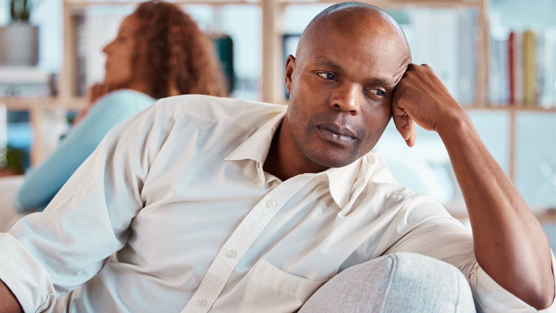 Judgmental man turned away from his wife.