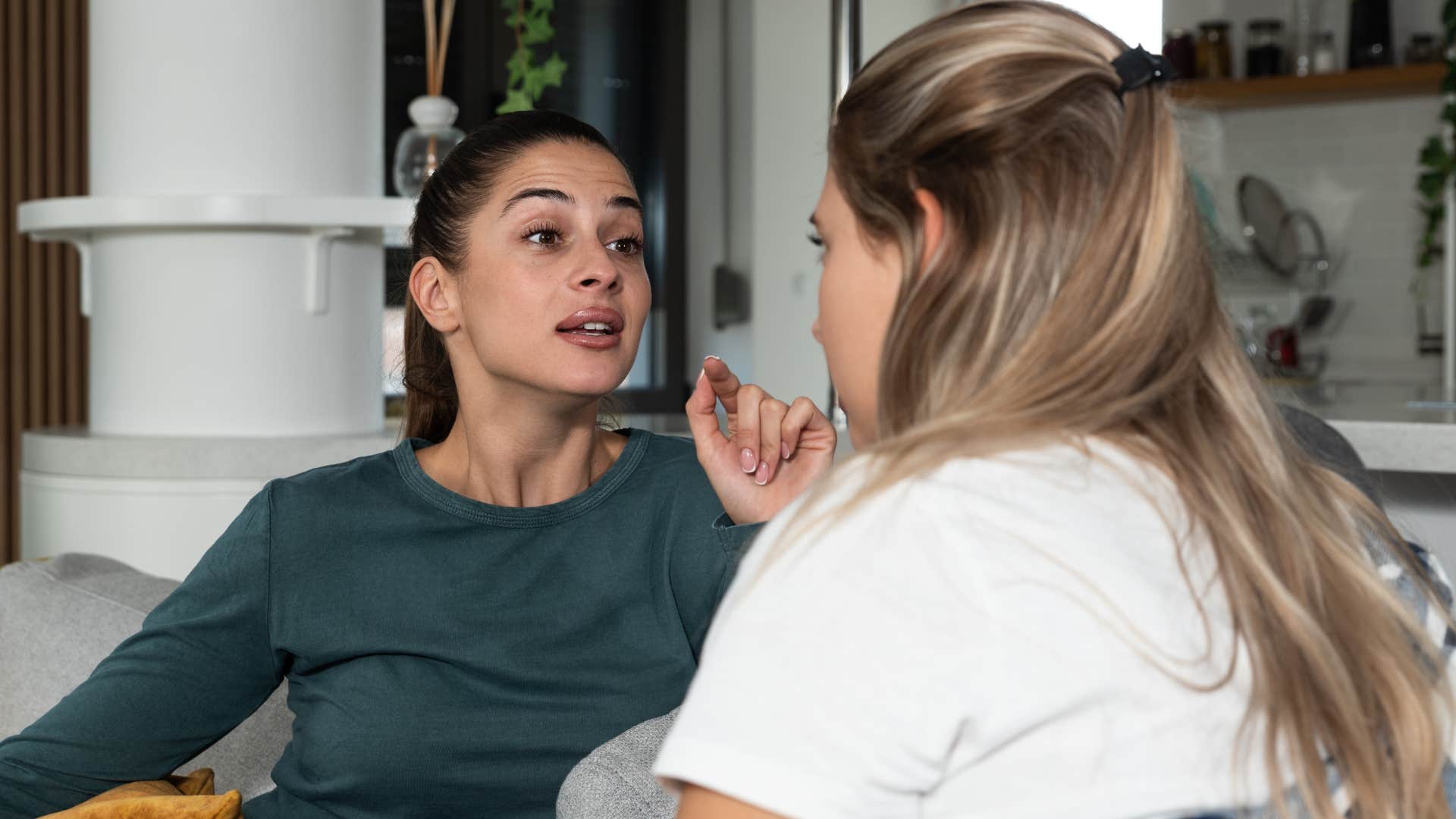 Woman calling her friend a "know-it-all" at home.