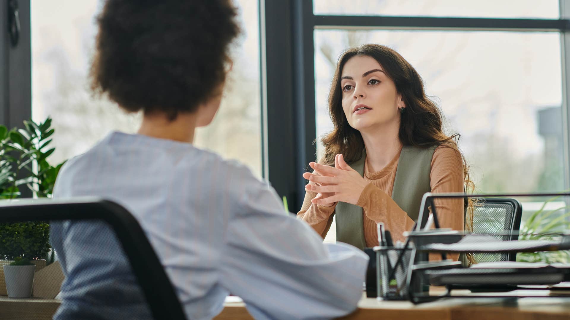 Woman saying "don't start this again" to her boss.